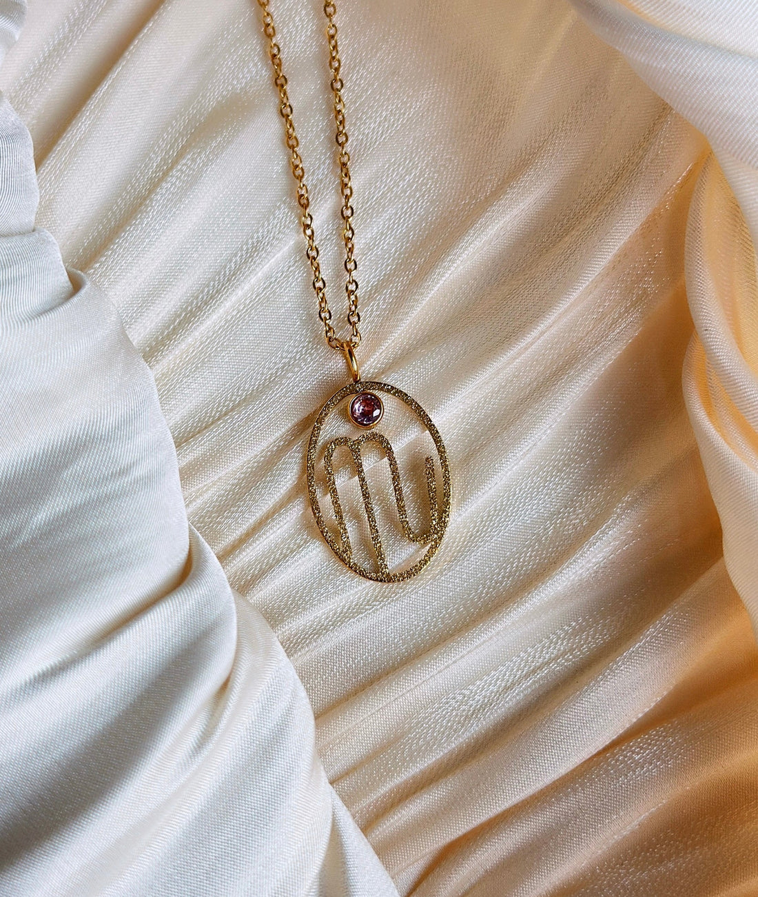 gold scorpio zodiac pendant necklace with purple gemstone