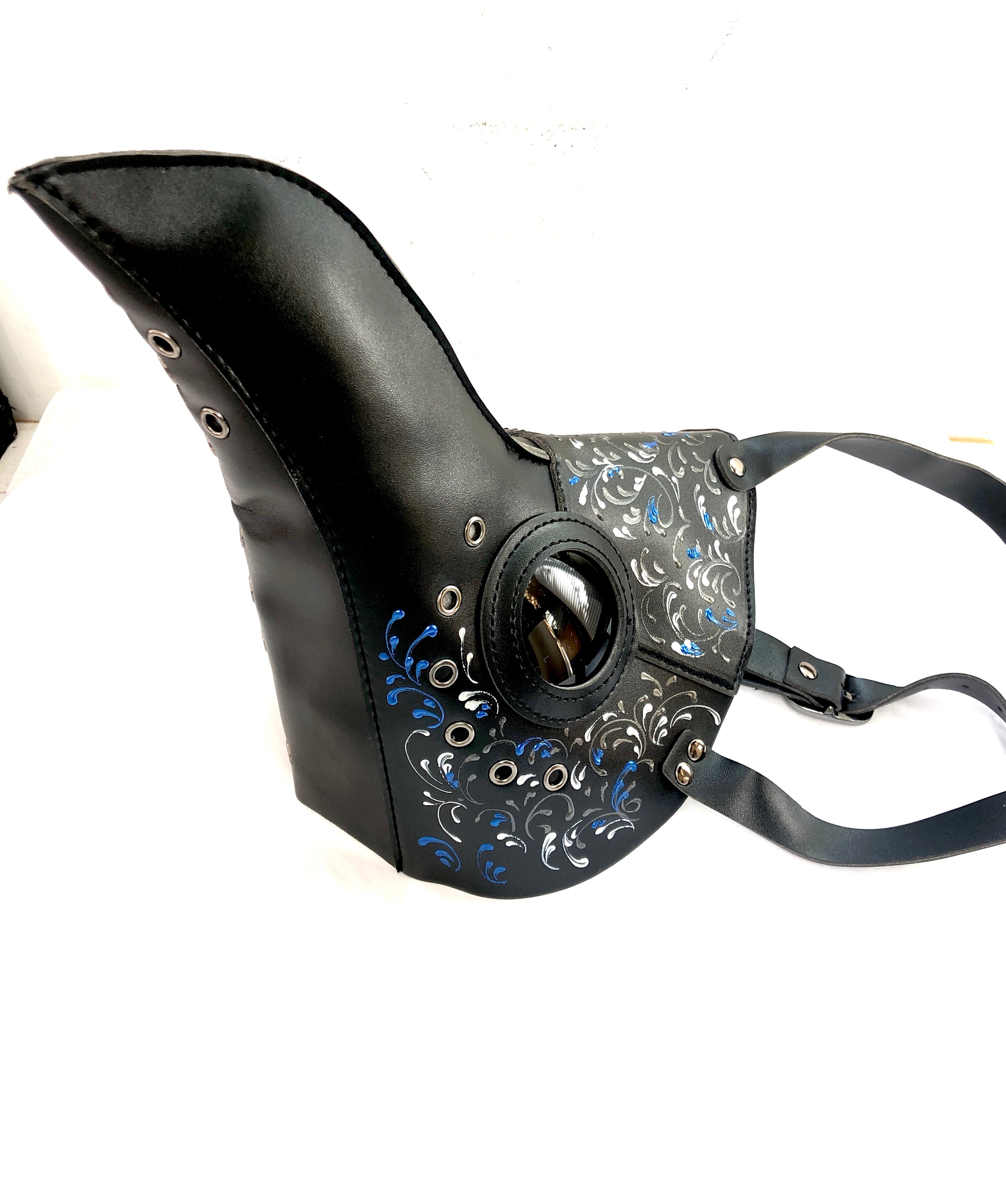 Gothic black & blue masquerade mask styled as a plague doctor with steampunk eye and pattern accents.