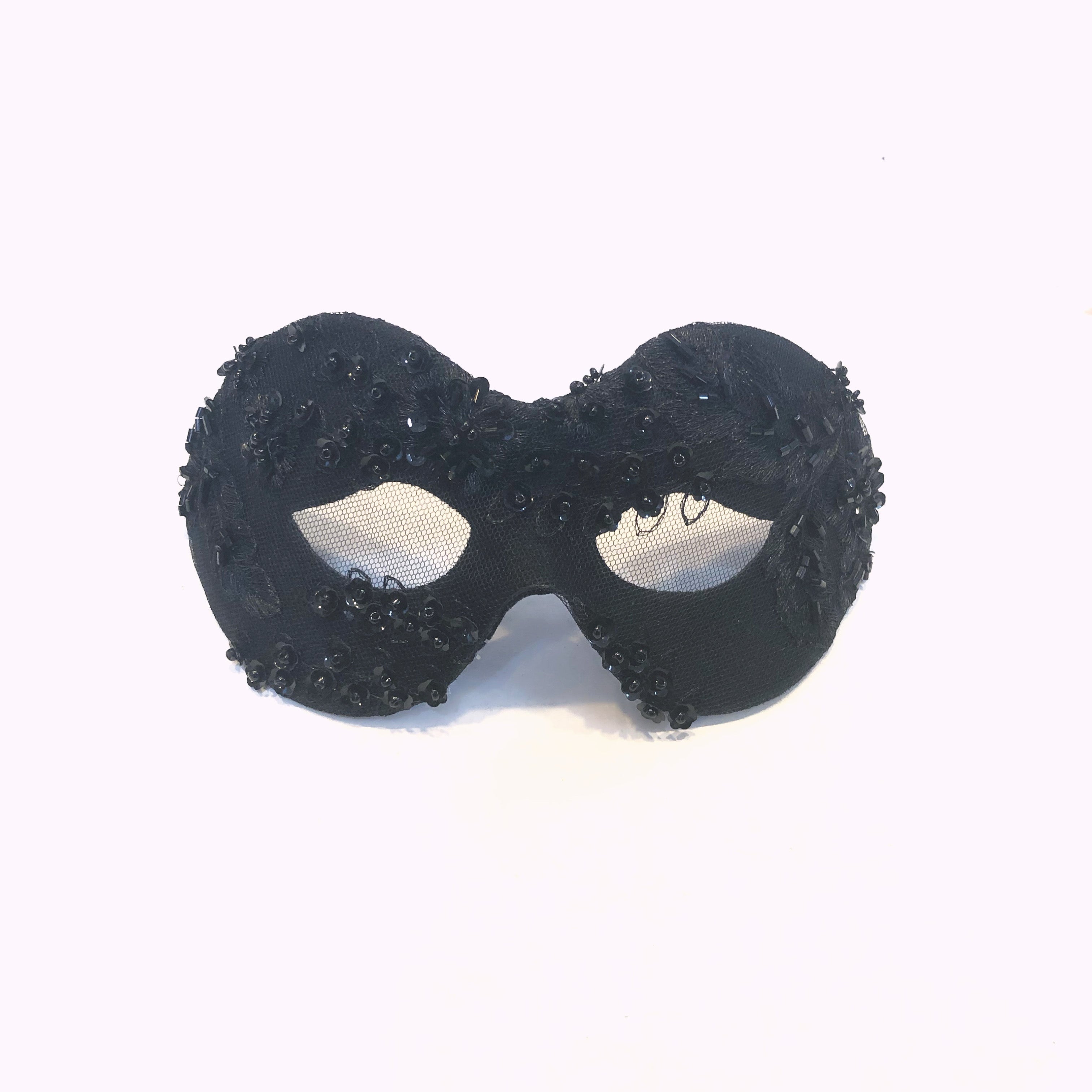 Black masquerade mask with sequin and bead detailing.