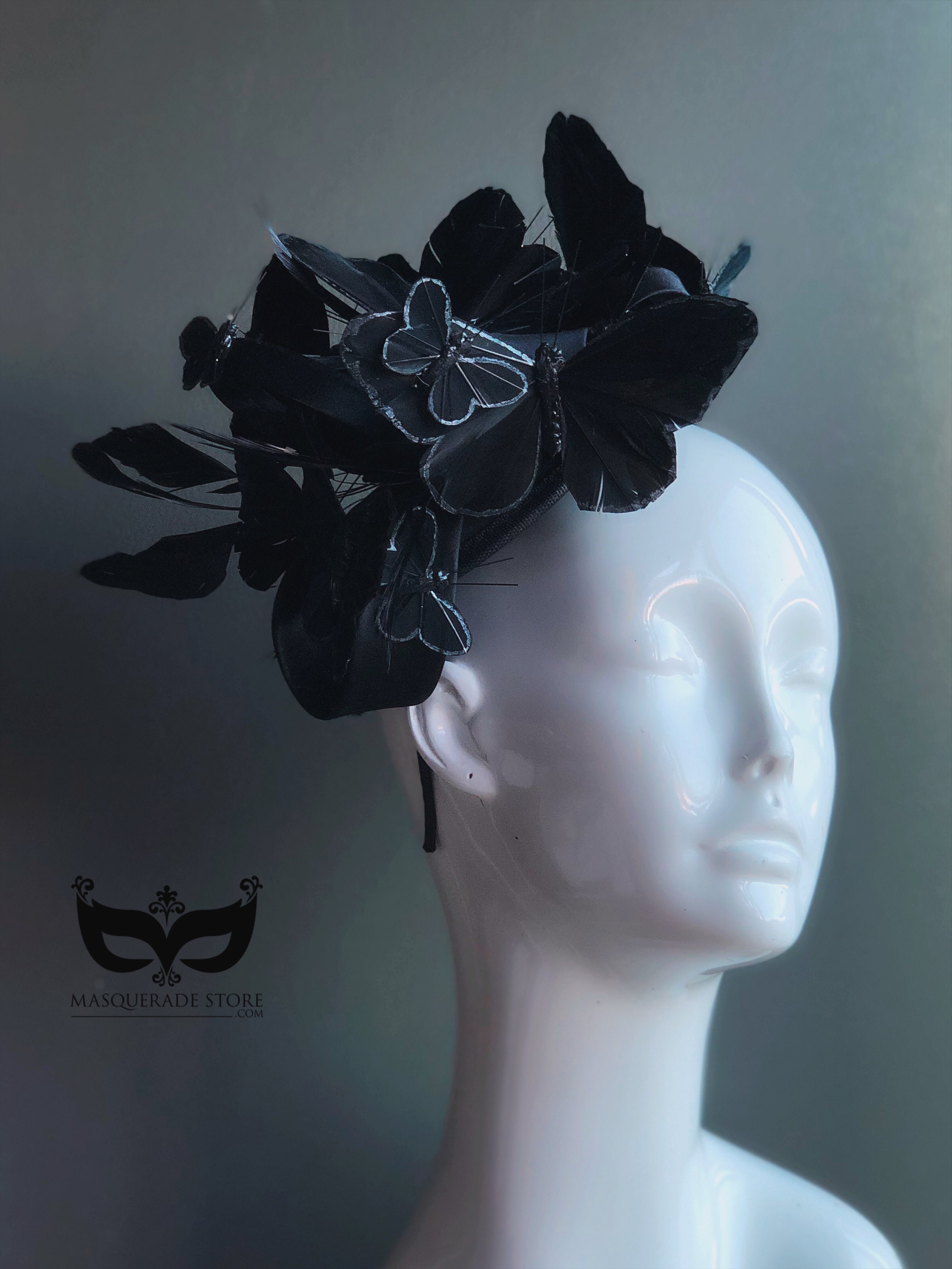 Black butterfly fascinator hat with layered butterflies and feathers for gothic masquerade or Halloween look.