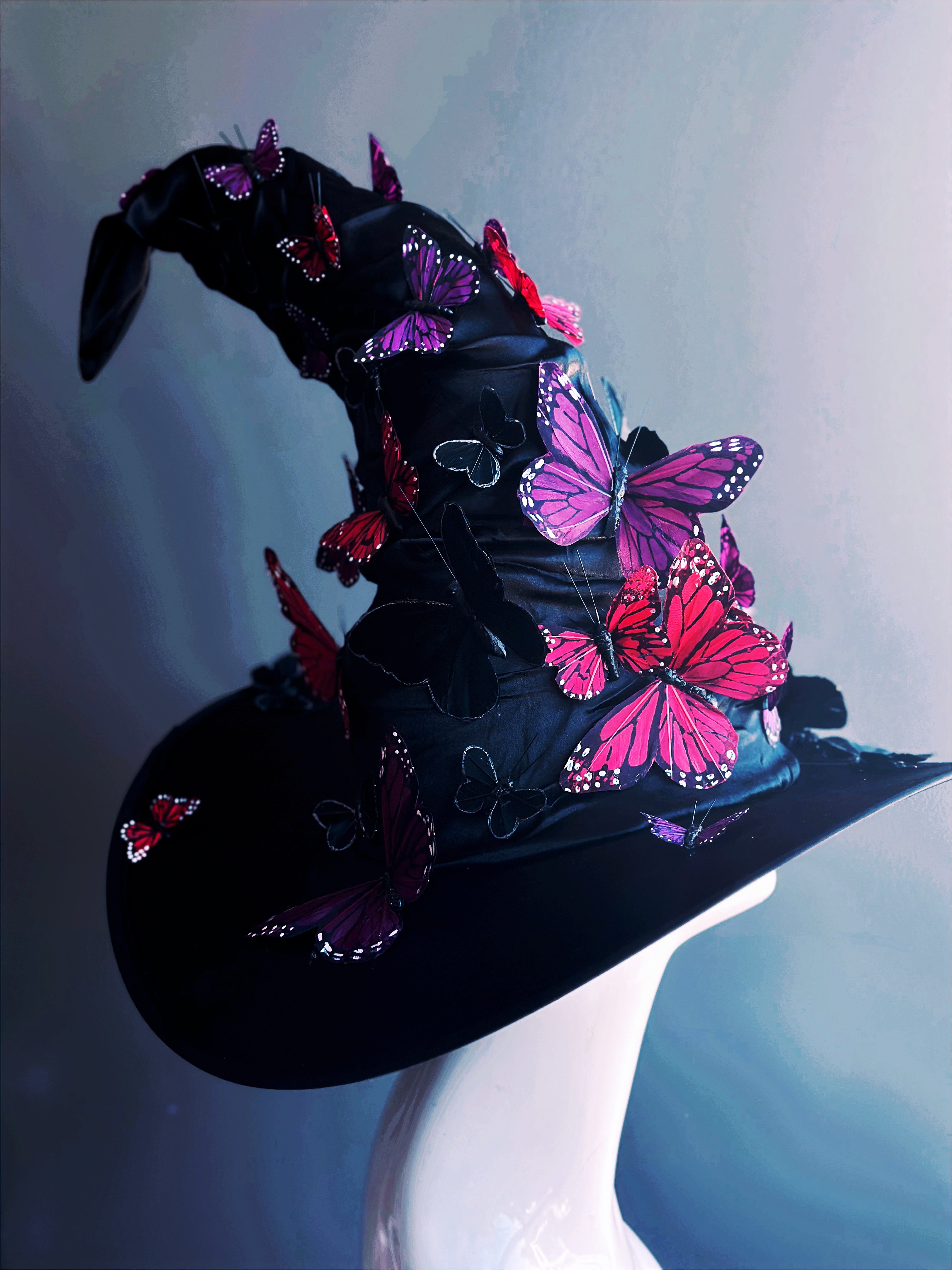 Halloween butterfly witch hat in black with pink and purple butterfly embellishments for fantasy or party styling
