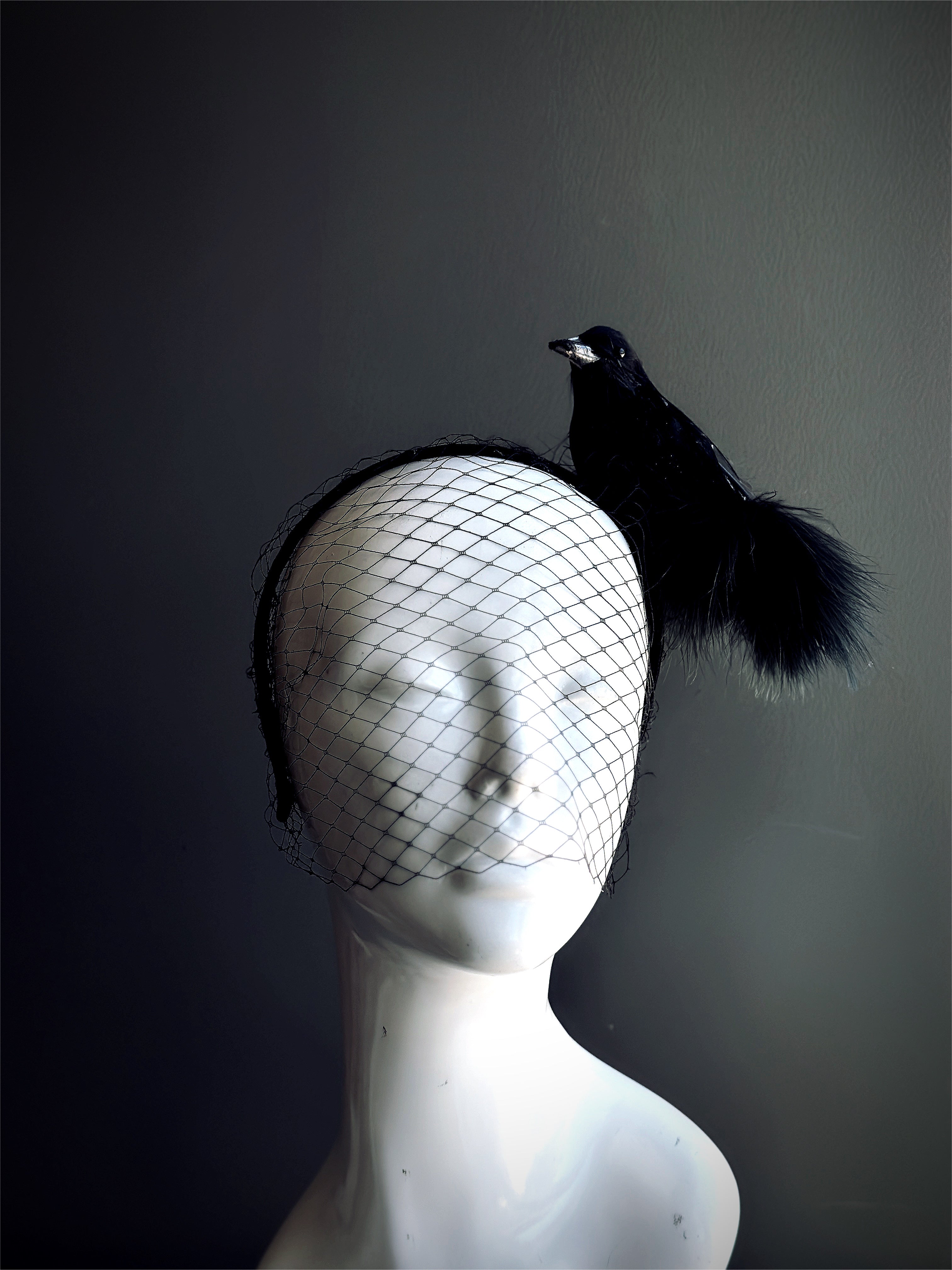 Black crow fascinator with mesh veil for gothic masquerade, witch costume, or Halloween outfit