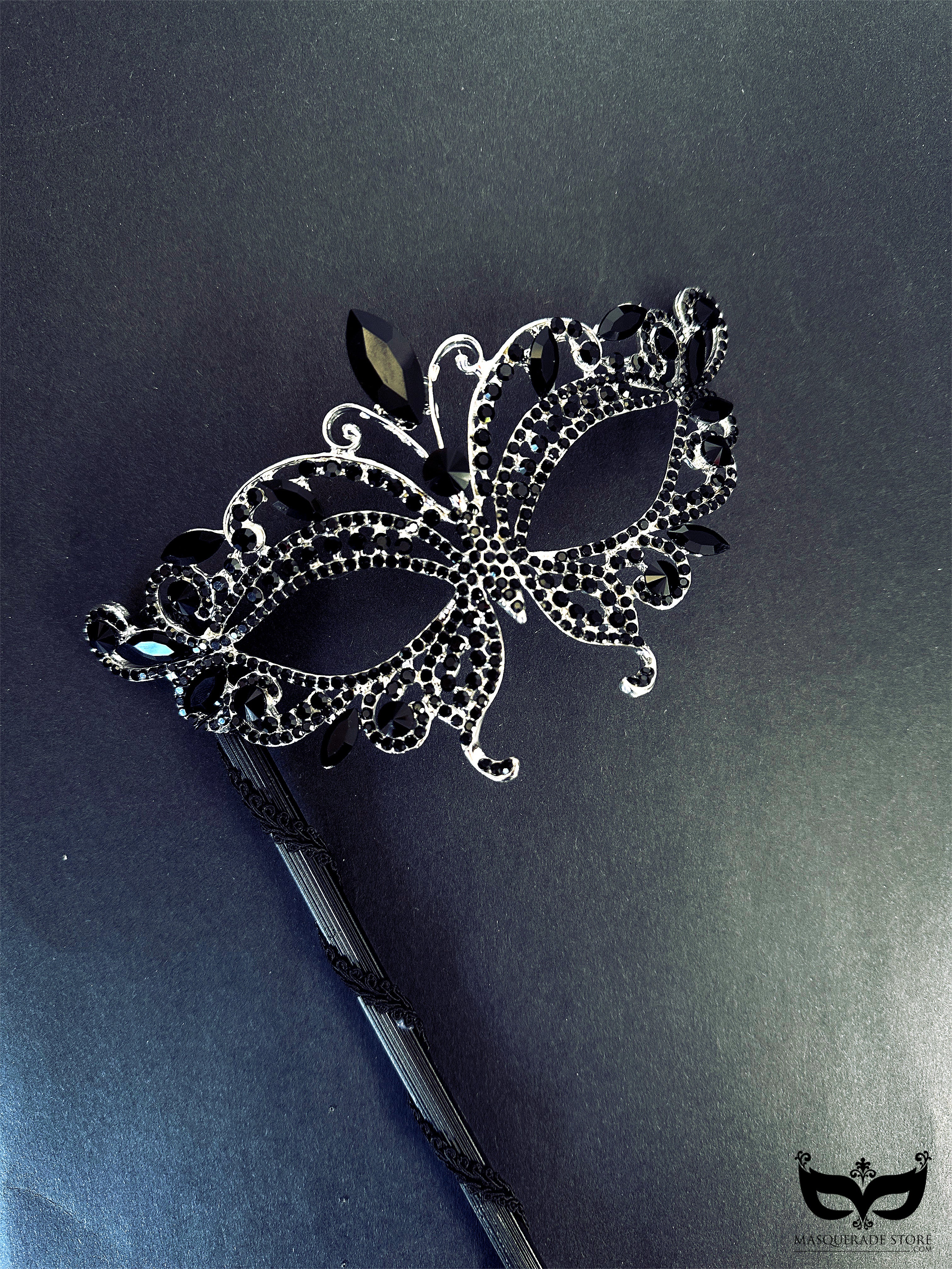 Elegant black masquerade mask on stick with crystal rhinestone jewels