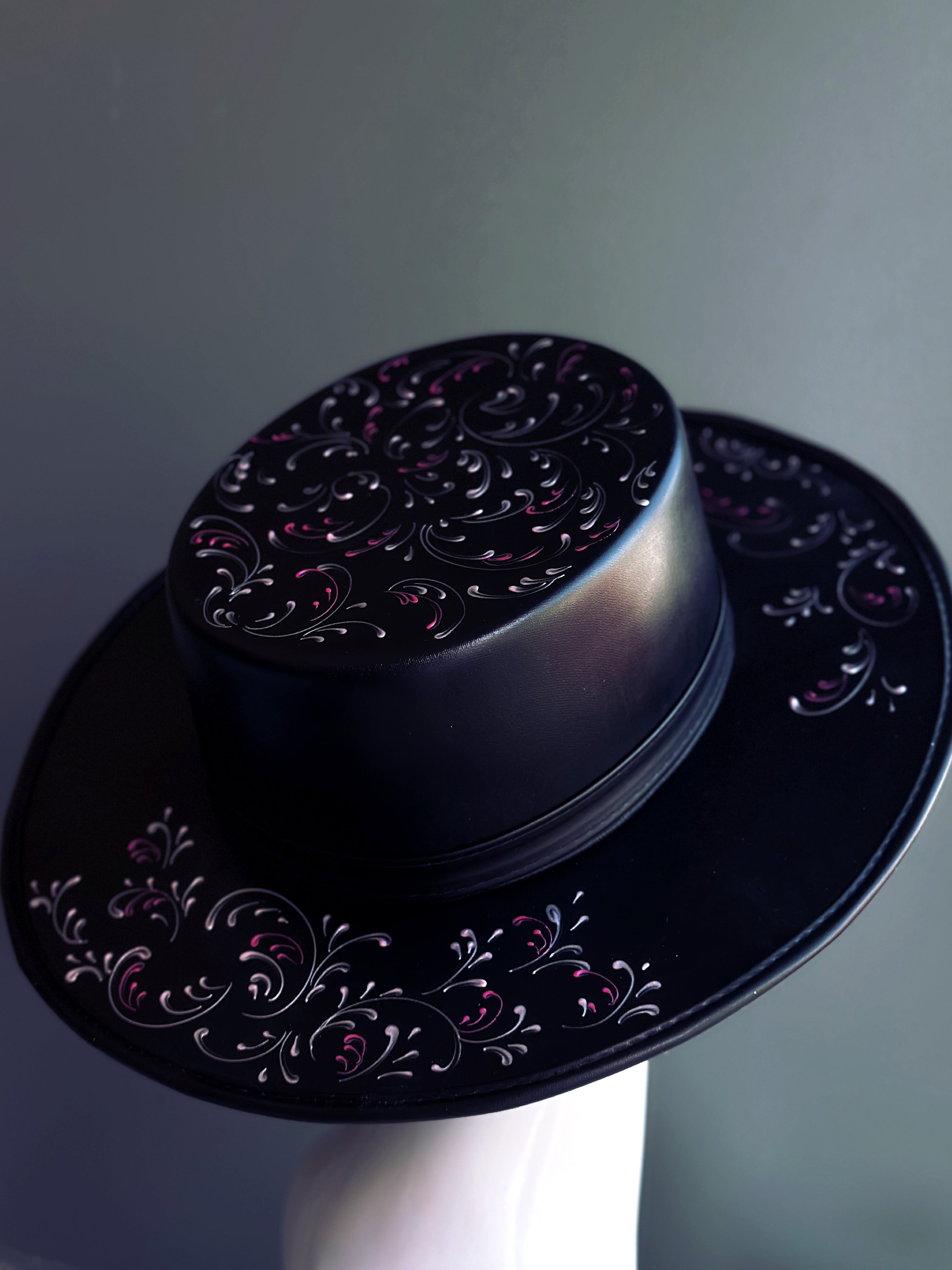 Plague-inspired black masquerade hat with pink scroll accents