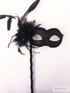 Venetian black filigree masquerade mask on stick with rhinestones.