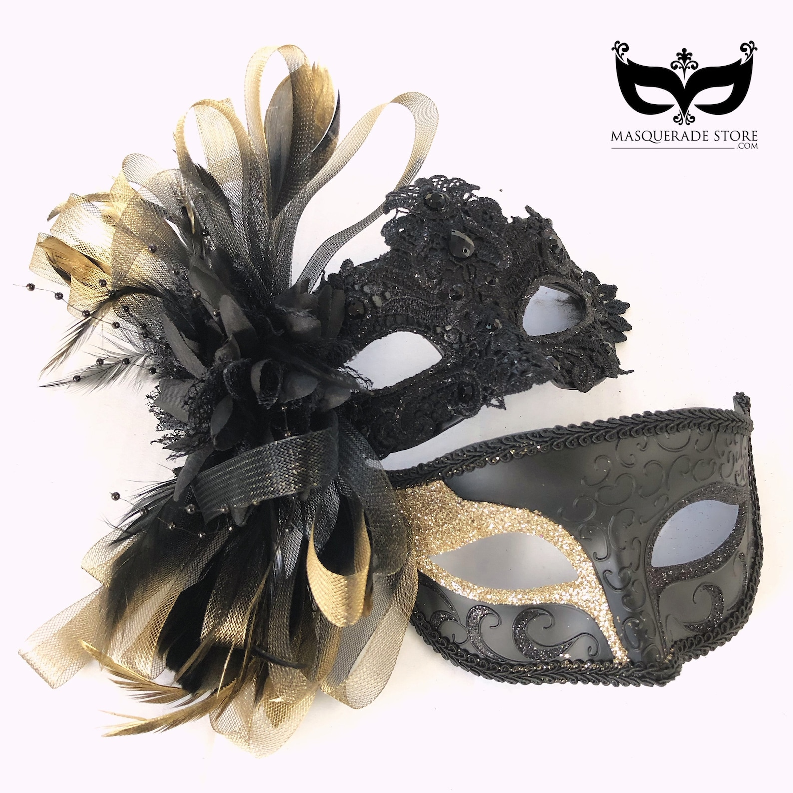 Couple’s masquerade mask set featuring a black lace feathered women’s mask and a men’s mask with gold glitter scrollwork.