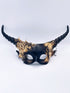 Dramatic masquerade mask with black twisted horns and gold gradient floral accents for costume balls or themed galas.