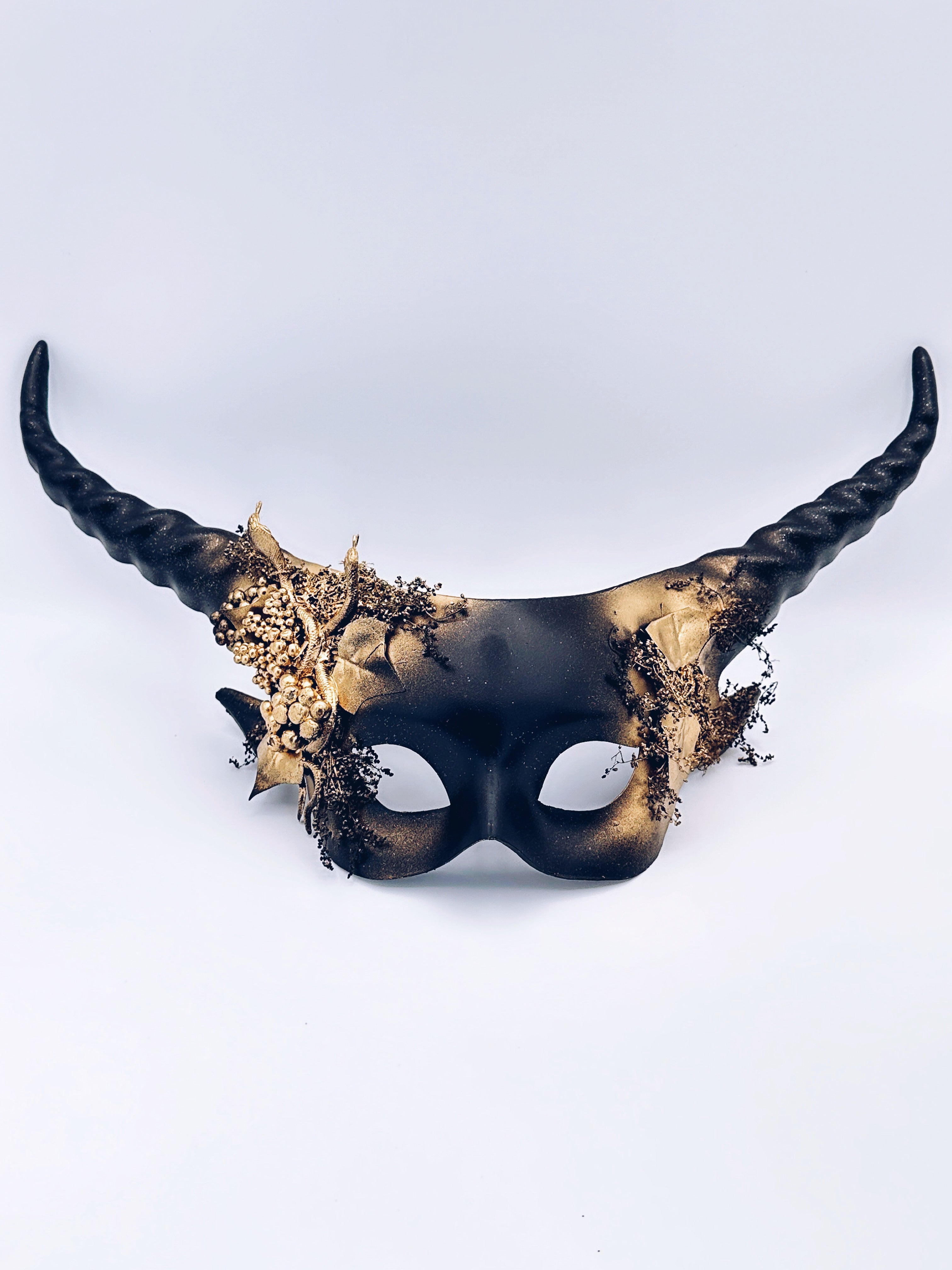Gothic black horn mask with gold botanical accents, ideal for cosplay or woodland masquerade