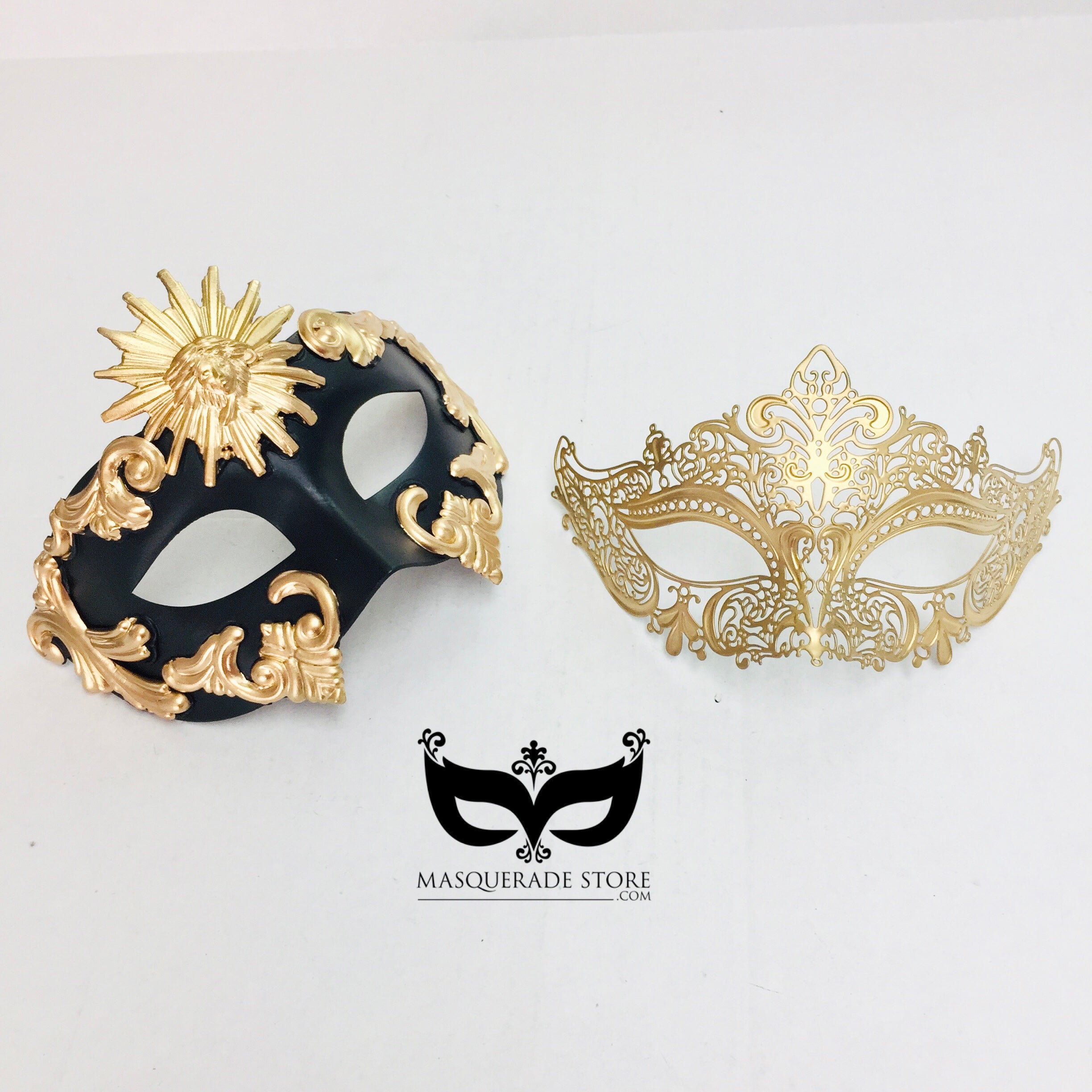 Black and gold couples masquerade mask set featuring a men’s baroque sun mask and a women’s golden filigree mask.