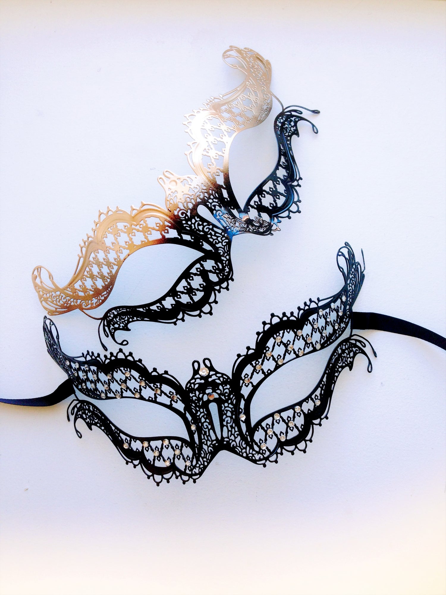 Elegant black masquerade masks in different filigree styles for prom, balls, or costume events.
