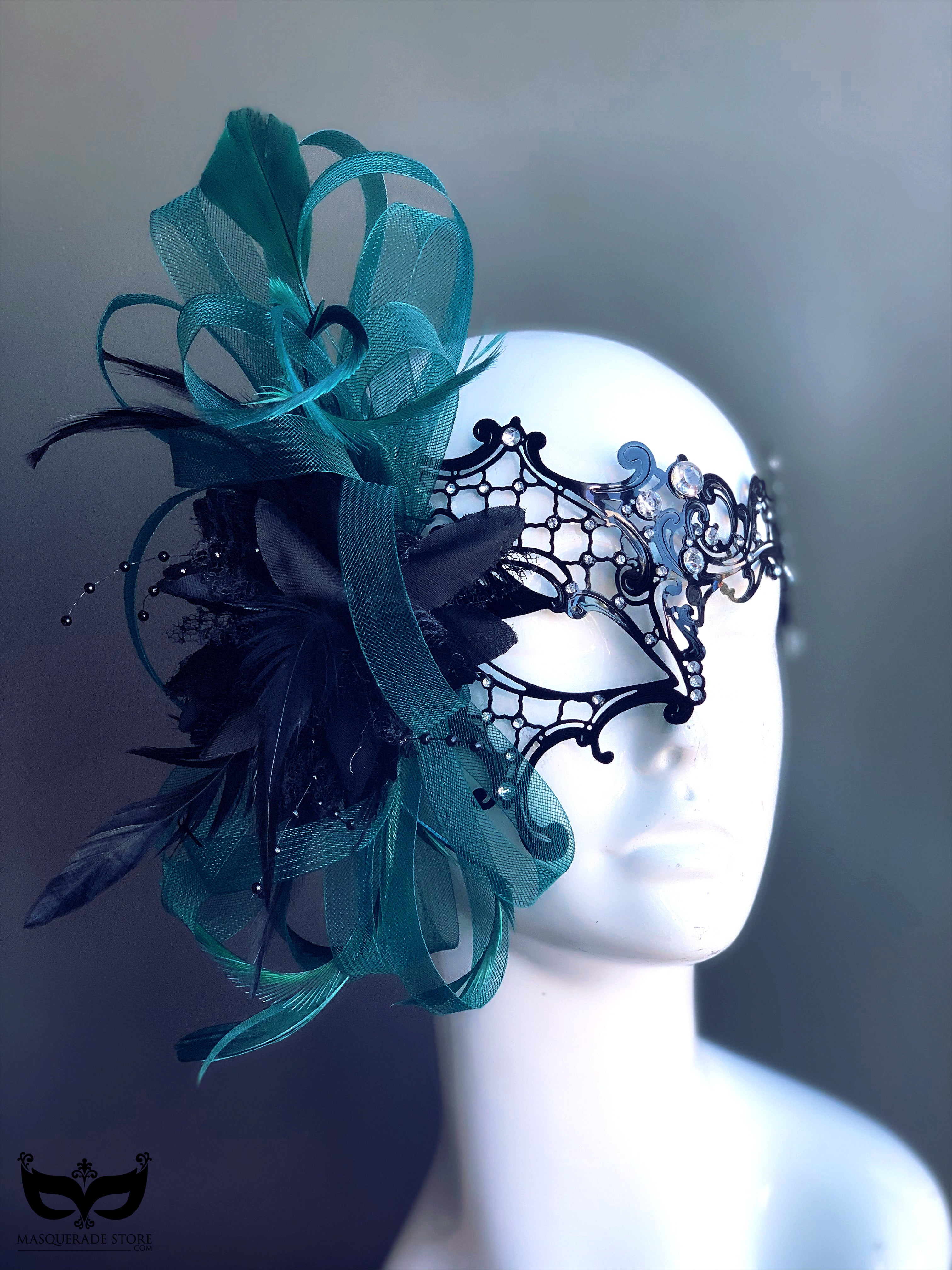 Black lace masquerade mask with teal tulle, feathers, and rhinestone accents for women.