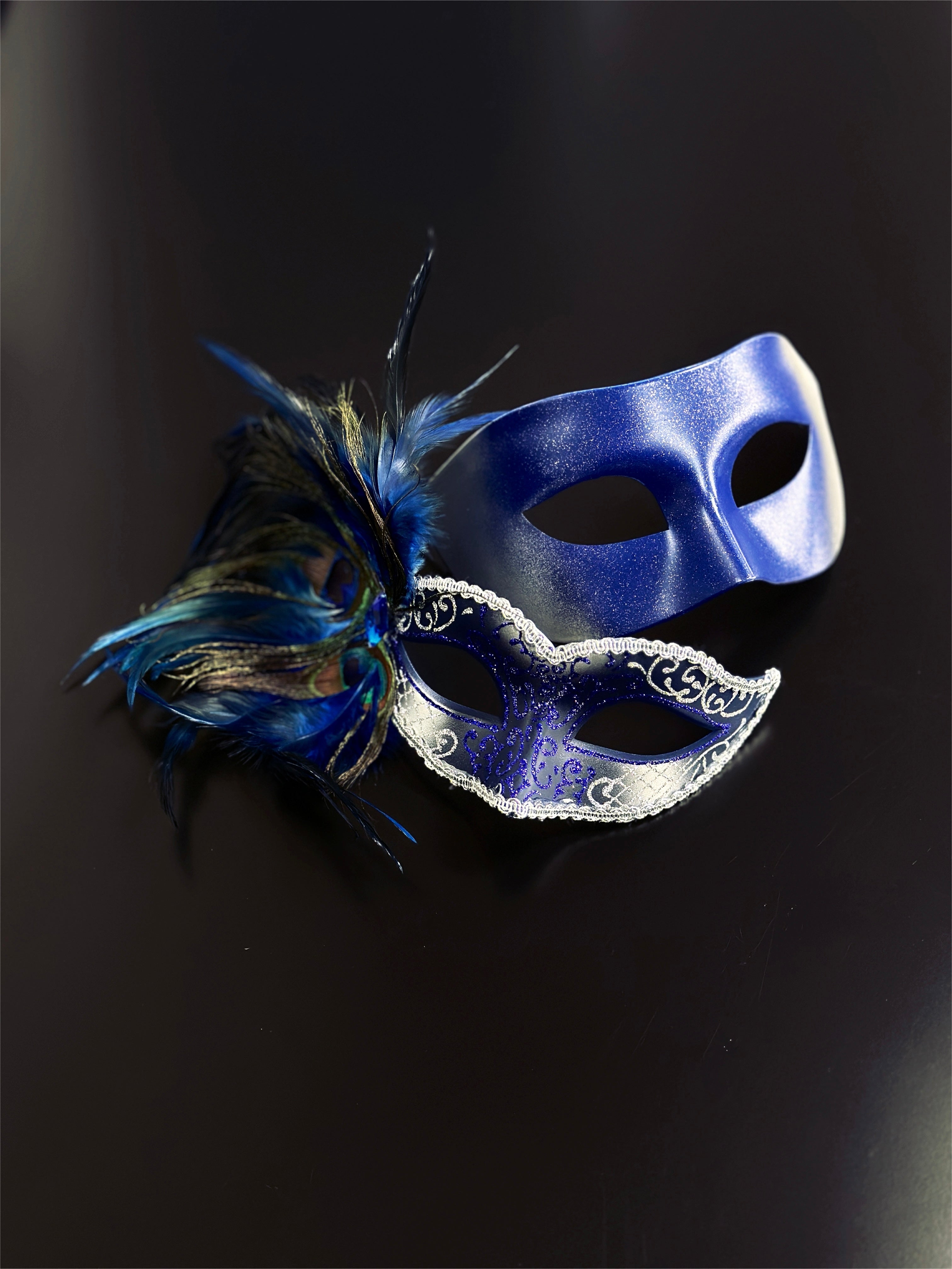 Blue and silver couples masquerade masks, one with peacock feathers and glitter details, perfect for Venetian balls, prom, and Mardi Gras events.
