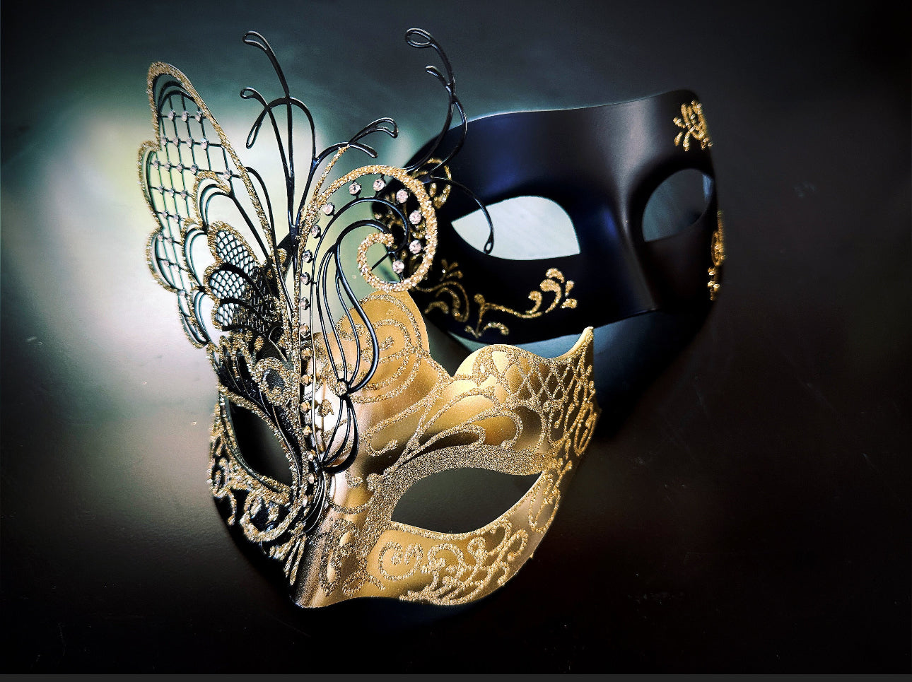 Elegant masquerade masks for couples featuring gold butterfly and black metallic mask