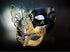 Elegant masquerade masks for couples featuring gold butterfly and black metallic mask