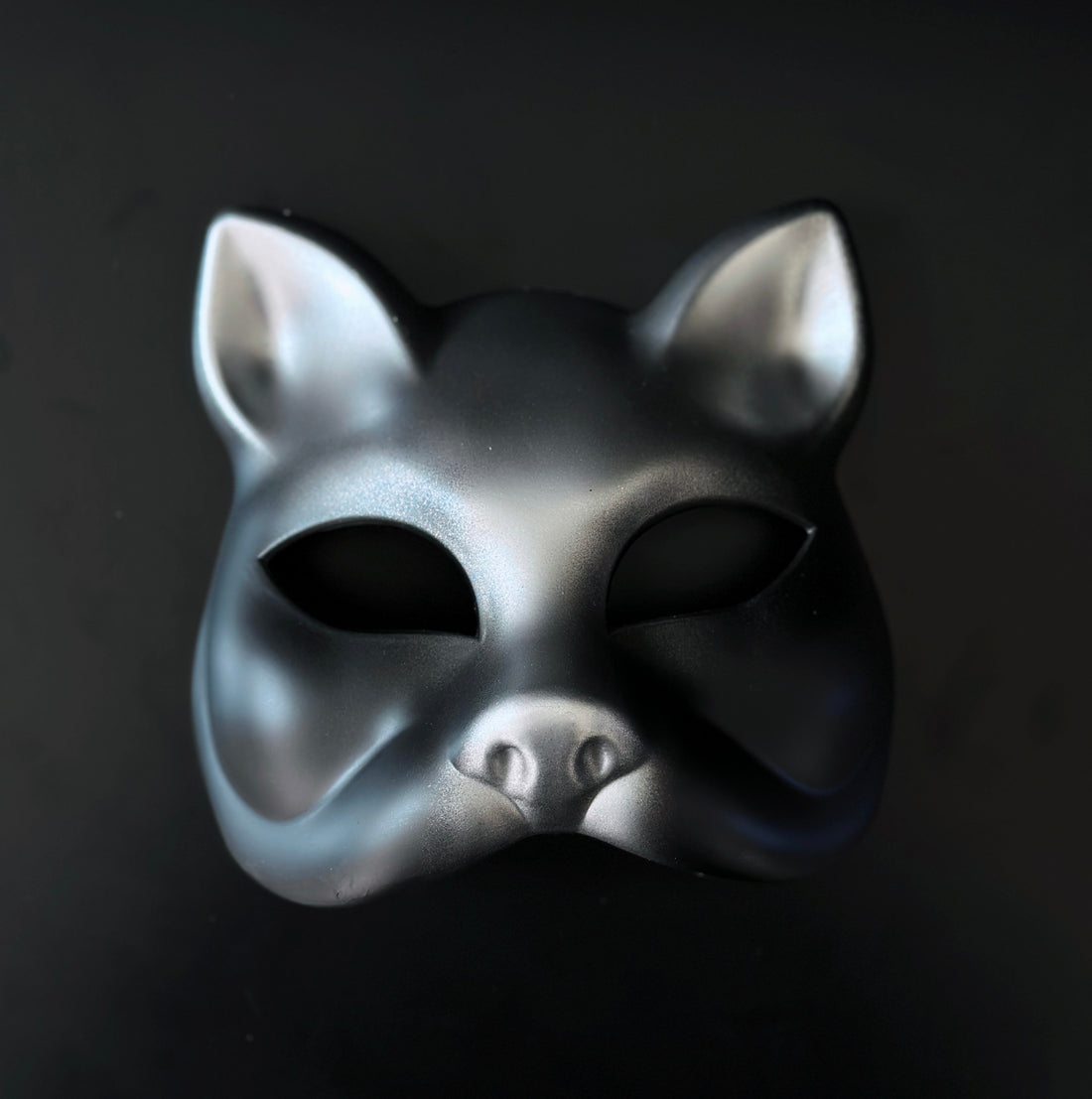 Silver and charcoal gray masquerade cat mask with sculpted feline design for costume and masquerade events.