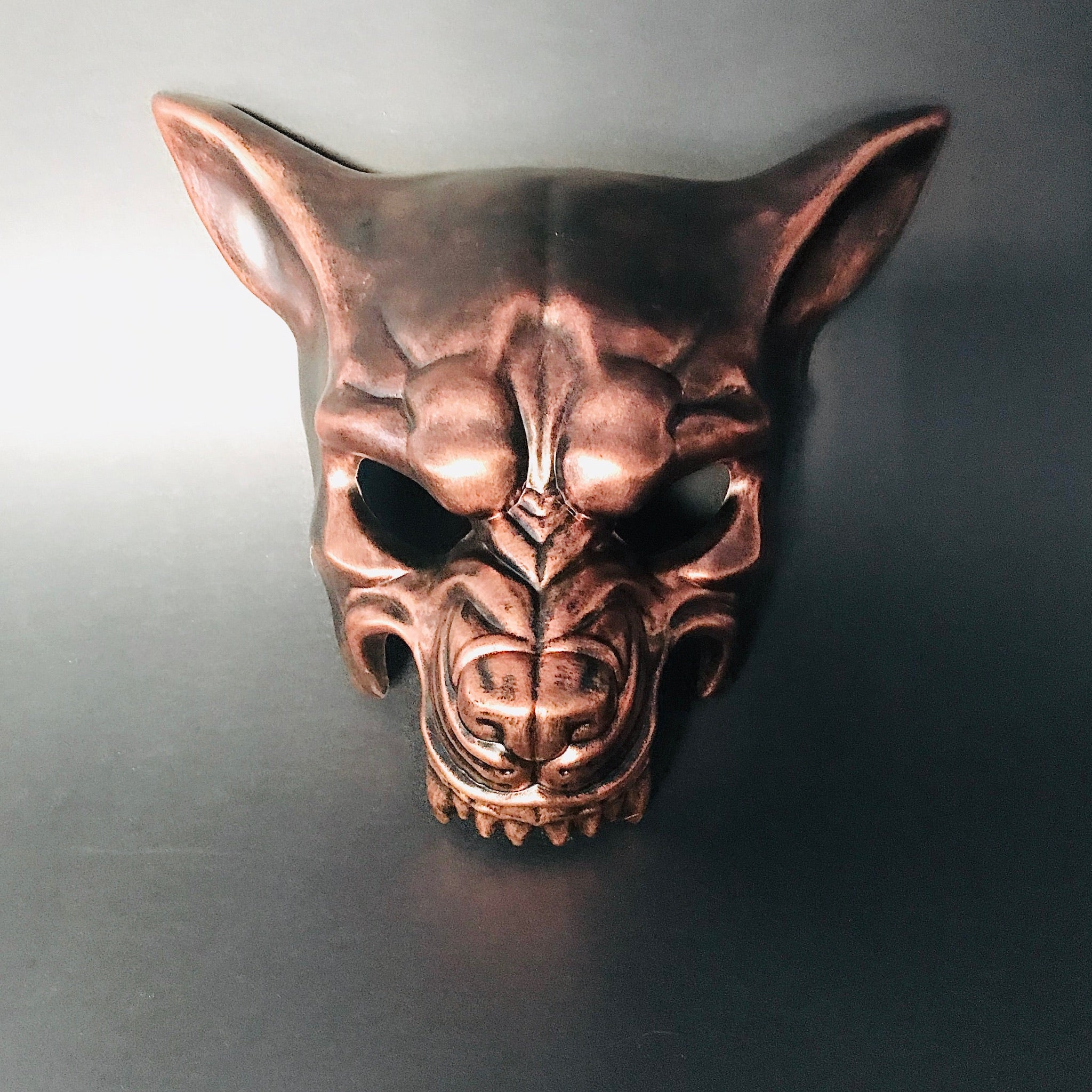 Bold copper-colored wolf mask with carved details for masquerade and costume events