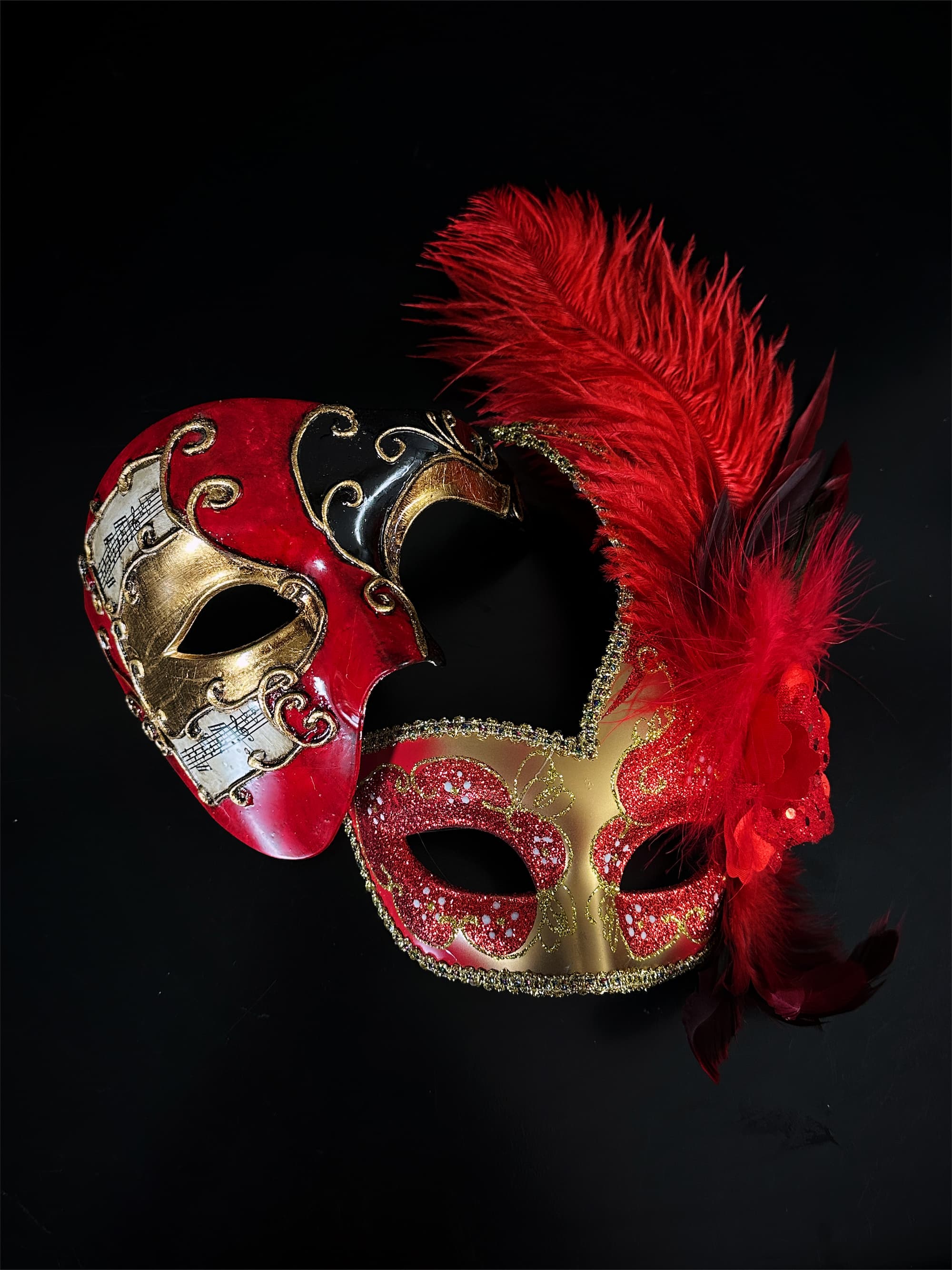 red masquerade dresses with mask Portrait of woman in red gown and red masquerade mask holding red rose Stock Photo