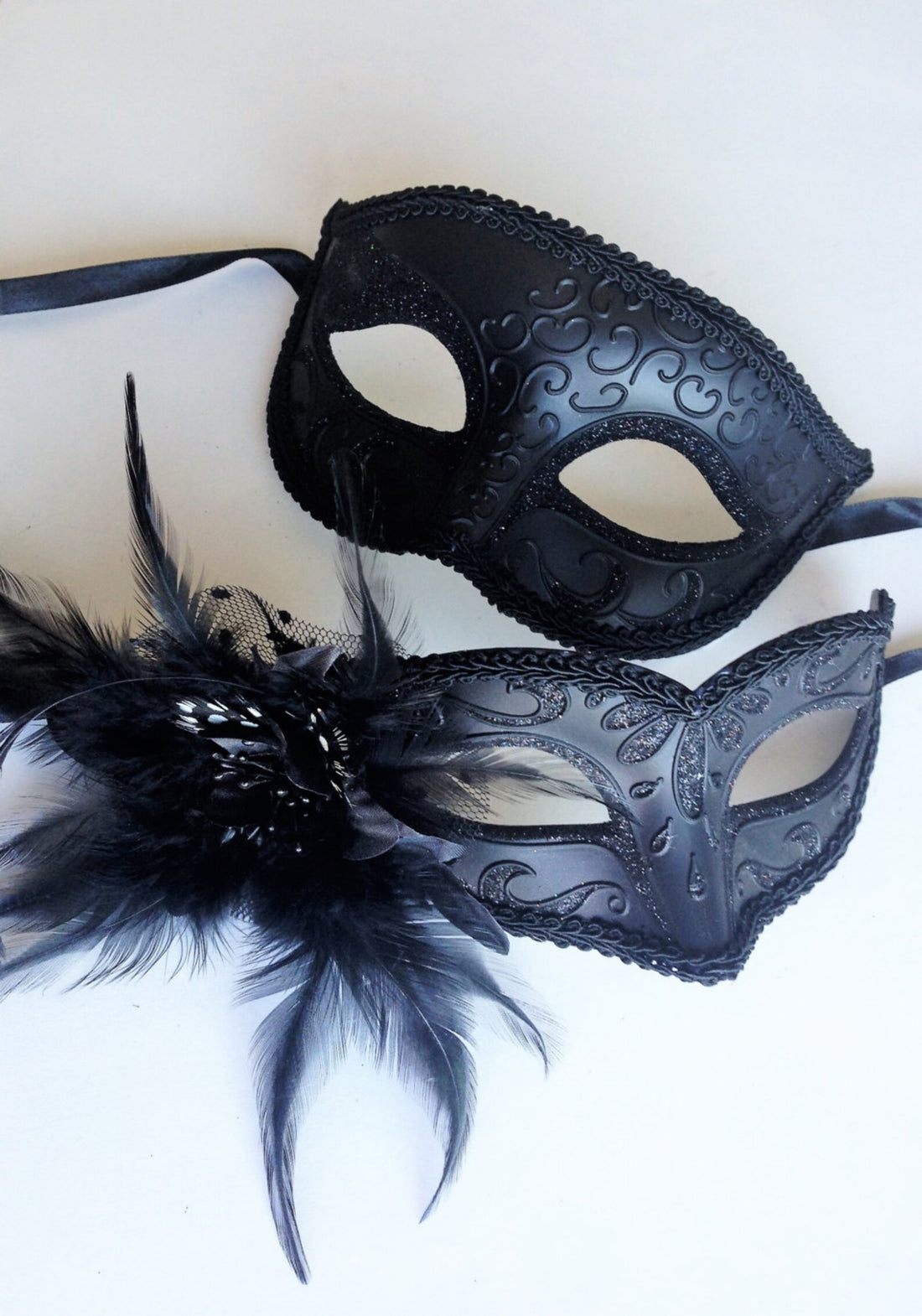 Couples masquerade mask set in black with shimmer and feathers on the women&