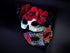 Gothic masquerade mask duo with Day of the Dead floral and skull elements in red and black for costume events.