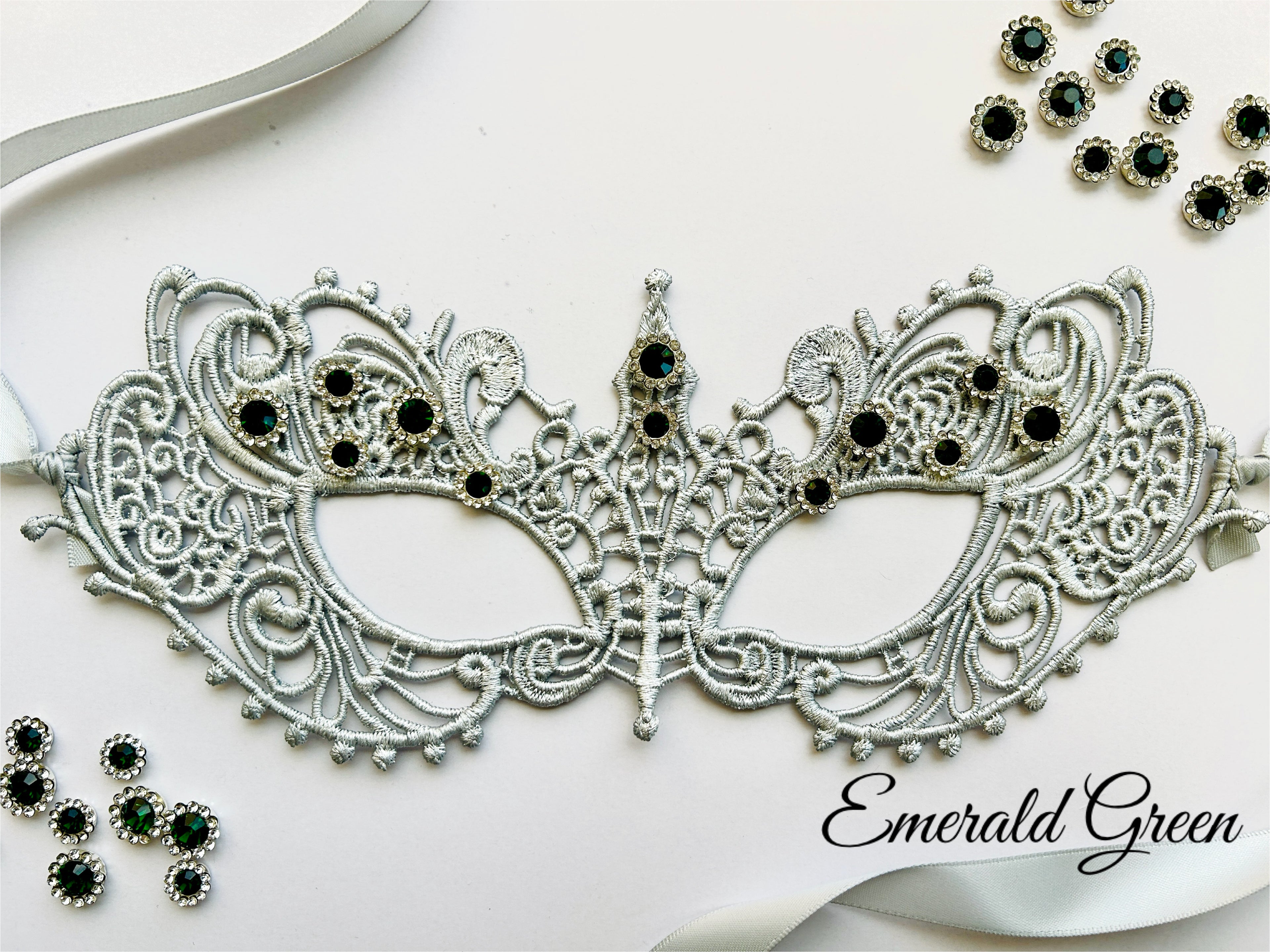 Silver lace masquerade mask with emerald green rhinestones for formal gala and Venetian ballroom occasions.