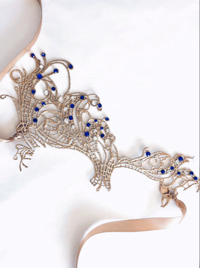 Intricate gold masquerade mask for women with sapphire gem details