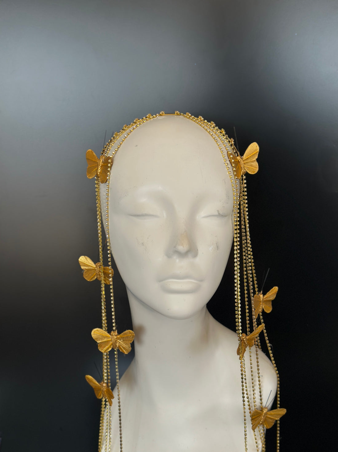 Gold butterfly crown with cascading chains and 3D butterflies for celestial goddess look.