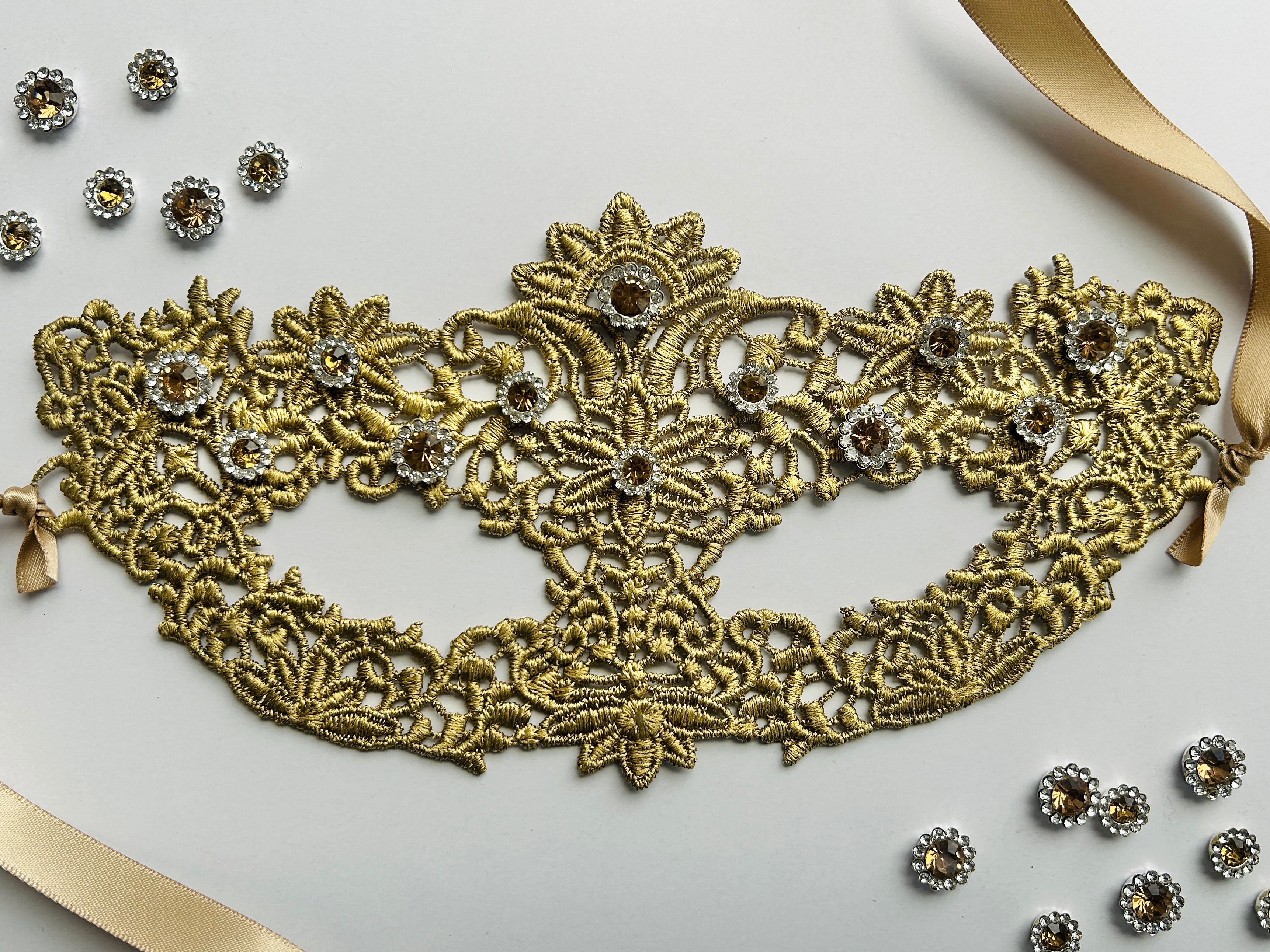 Gold lace masquerade mask with rhinestones for ballroom gala and Venetian masquerade events.