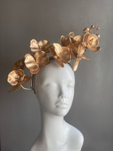 Metallic orchid flower crown in gold, styled for masquerade or bridal accessories