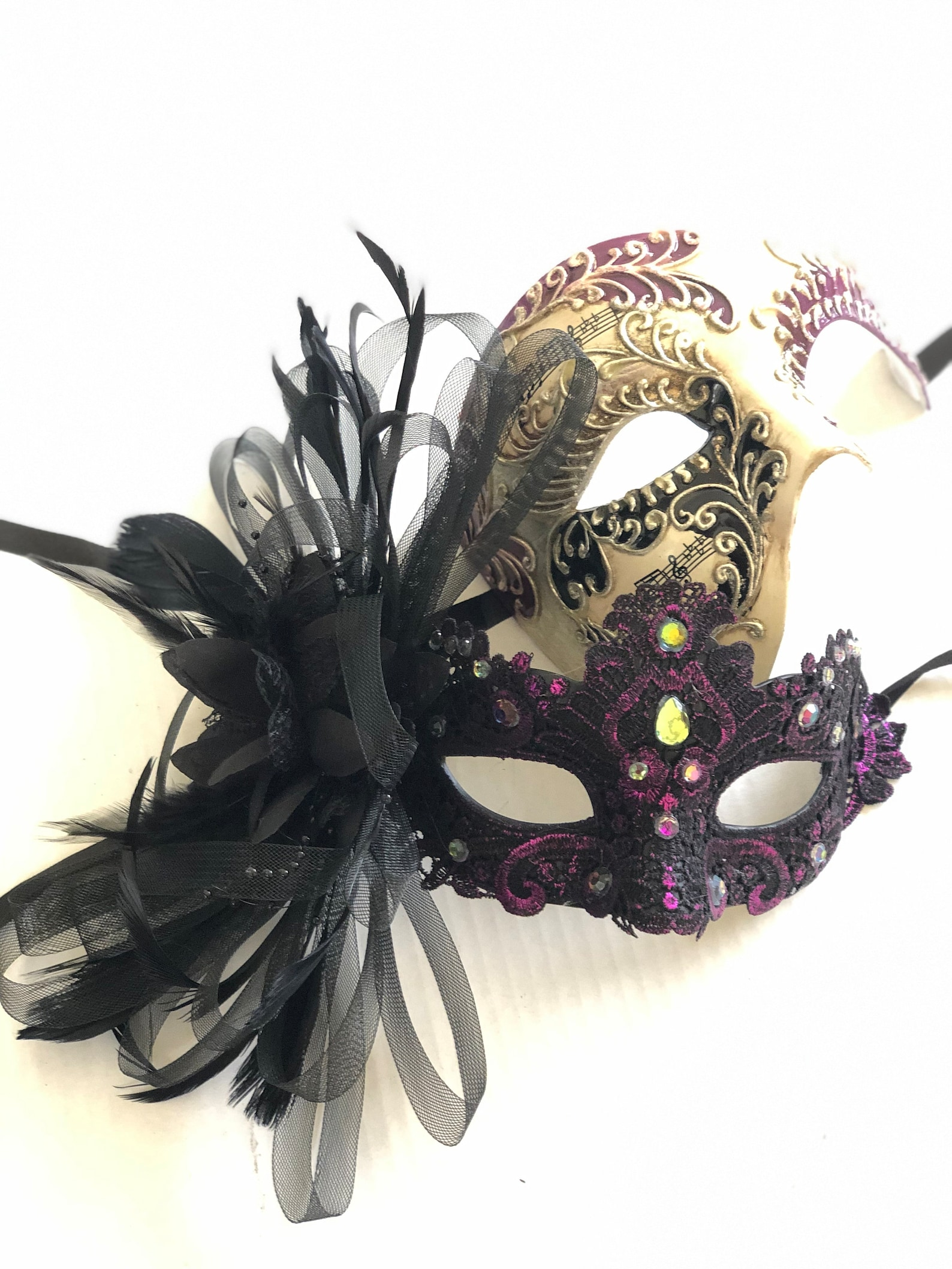 Gold and purple couples masquerade masks with lace, rhinestones, and feather accents.