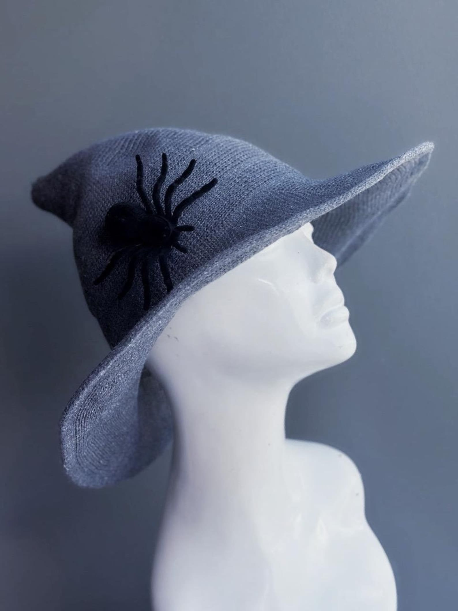 Gray witch hat with black spider accent for Halloween, gothic, or cosplay costumes.