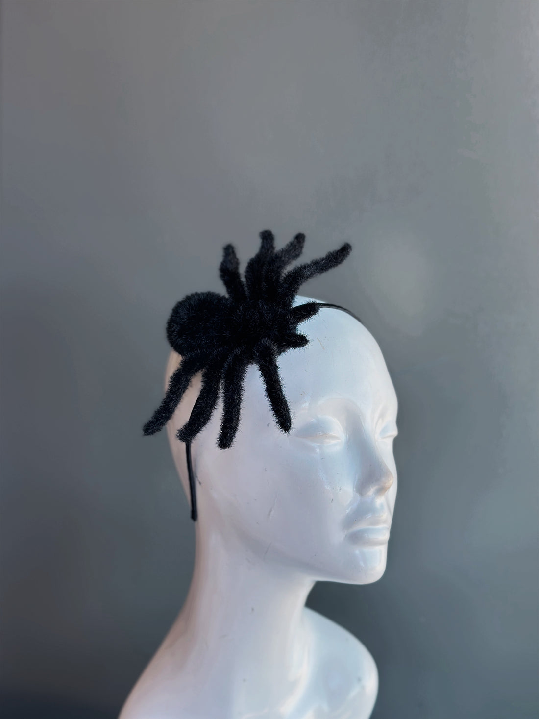 Halloween spider fascinator headband with fuzzy black spider design for costumes and parties.