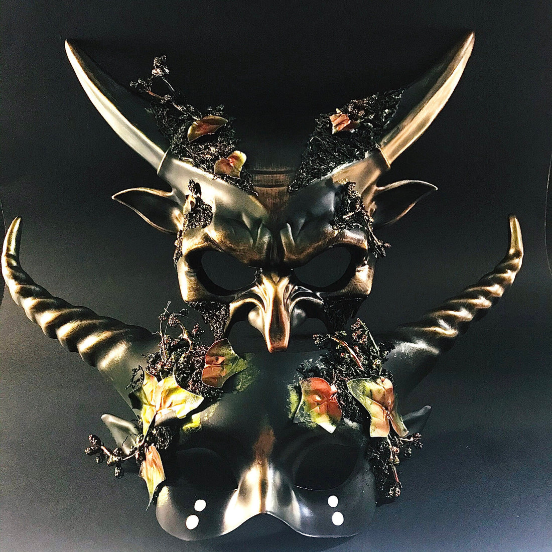 Gothic-style masquerade masks with horns, bronze detailing, and fall leaf accents, ideal for Halloween or prom.
