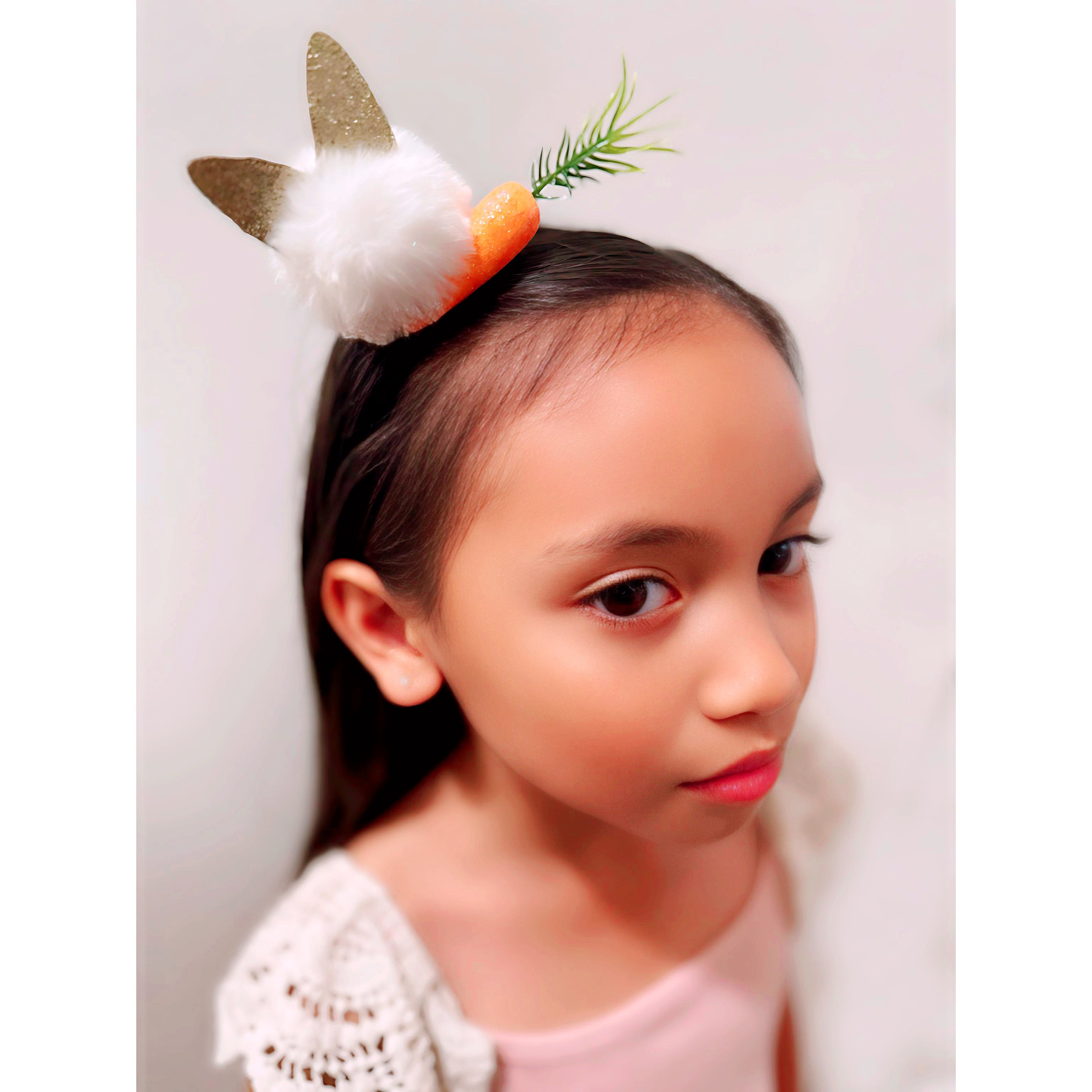 White fluffy ball with bunny ears and a carrot.