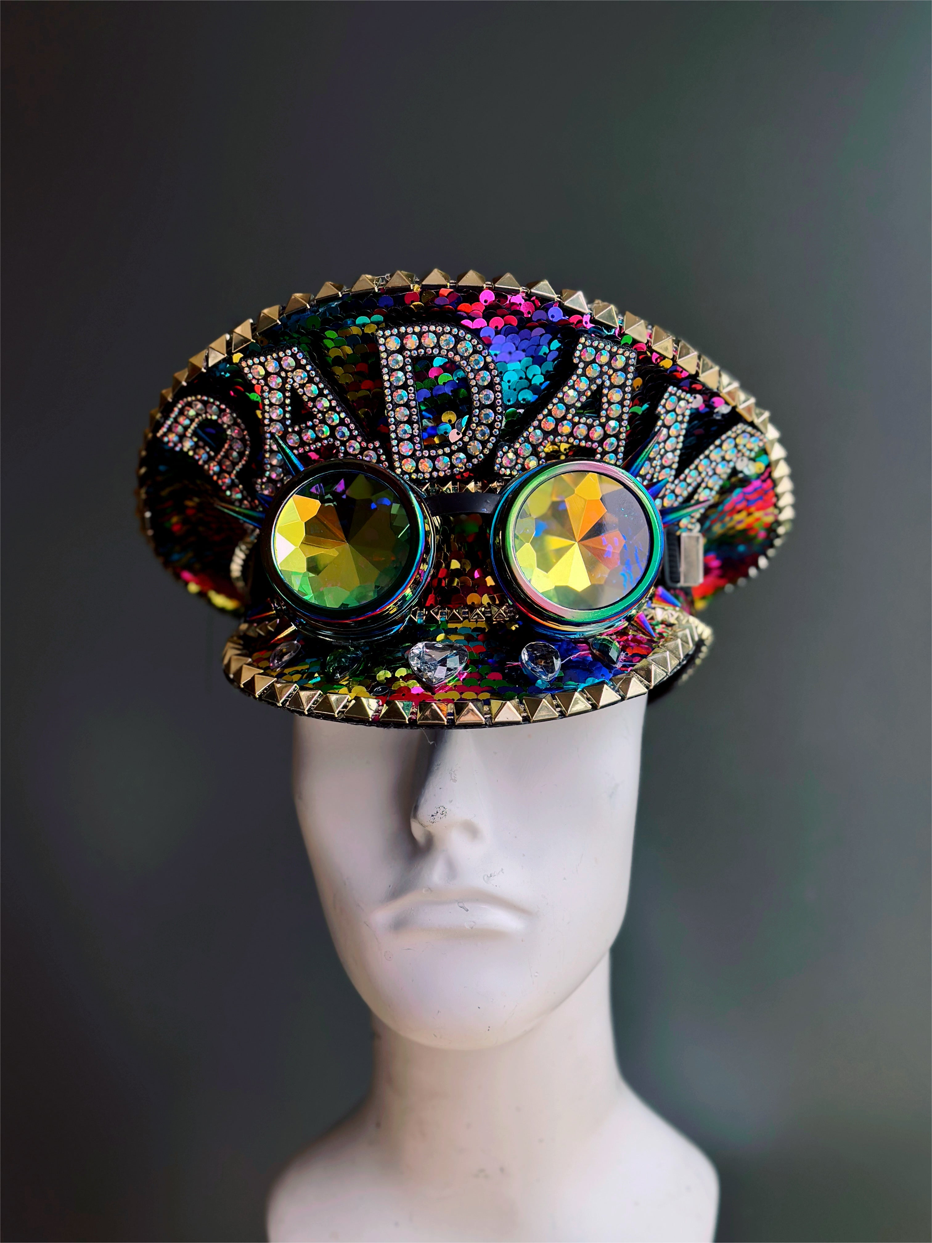 Rainbow captain hat with the word "Padam" and goggles.