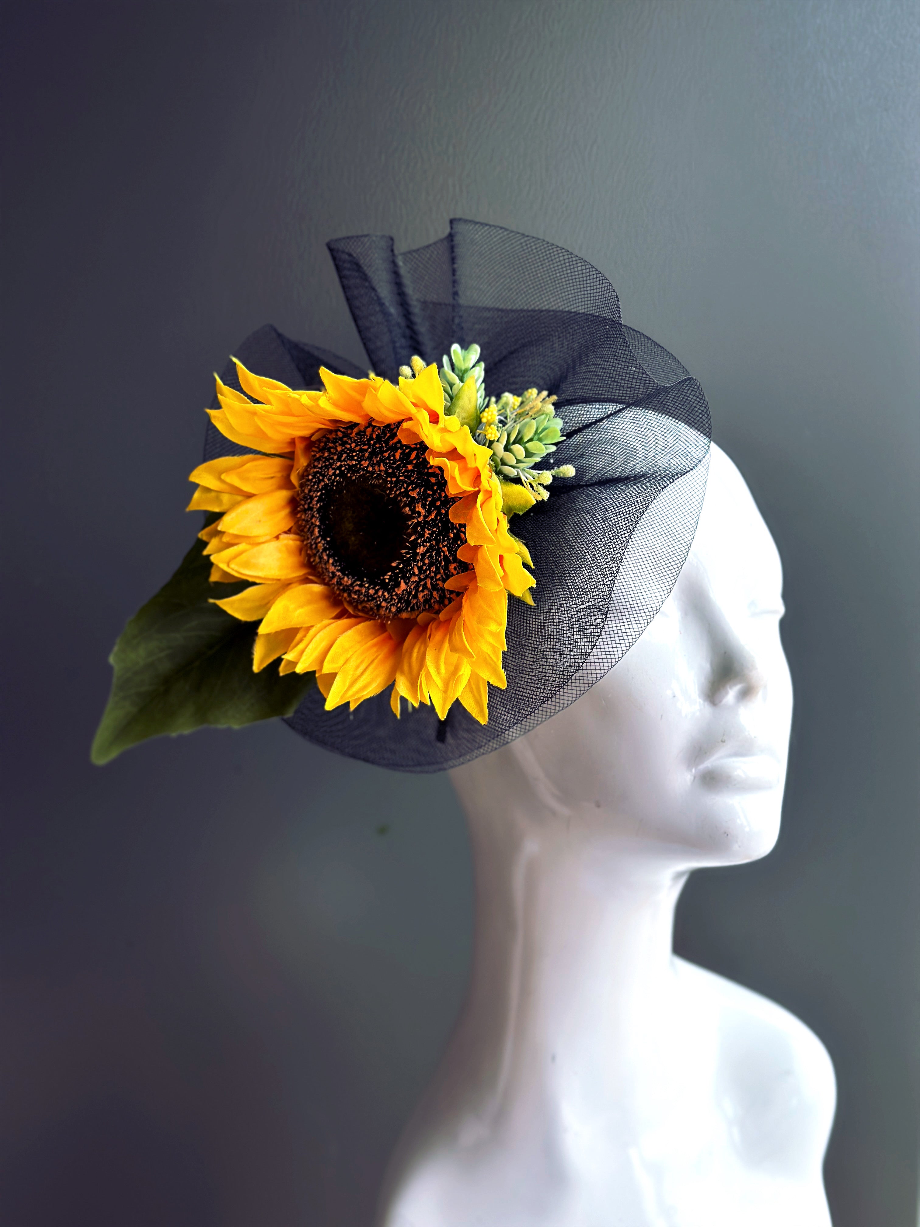 Sunflower on top of black tulle fascinator.