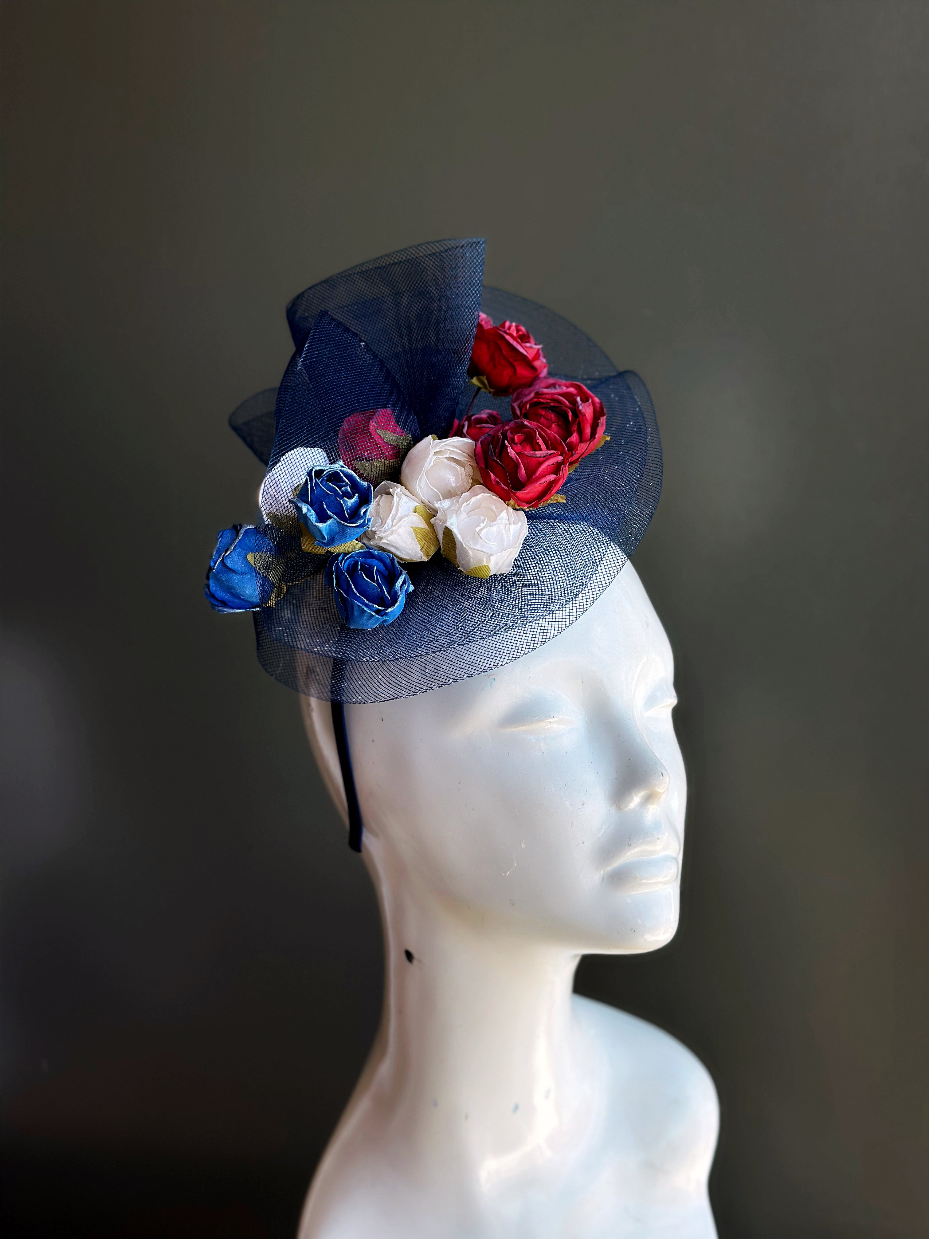 Red, white, and blue roses on a blue tulle base.