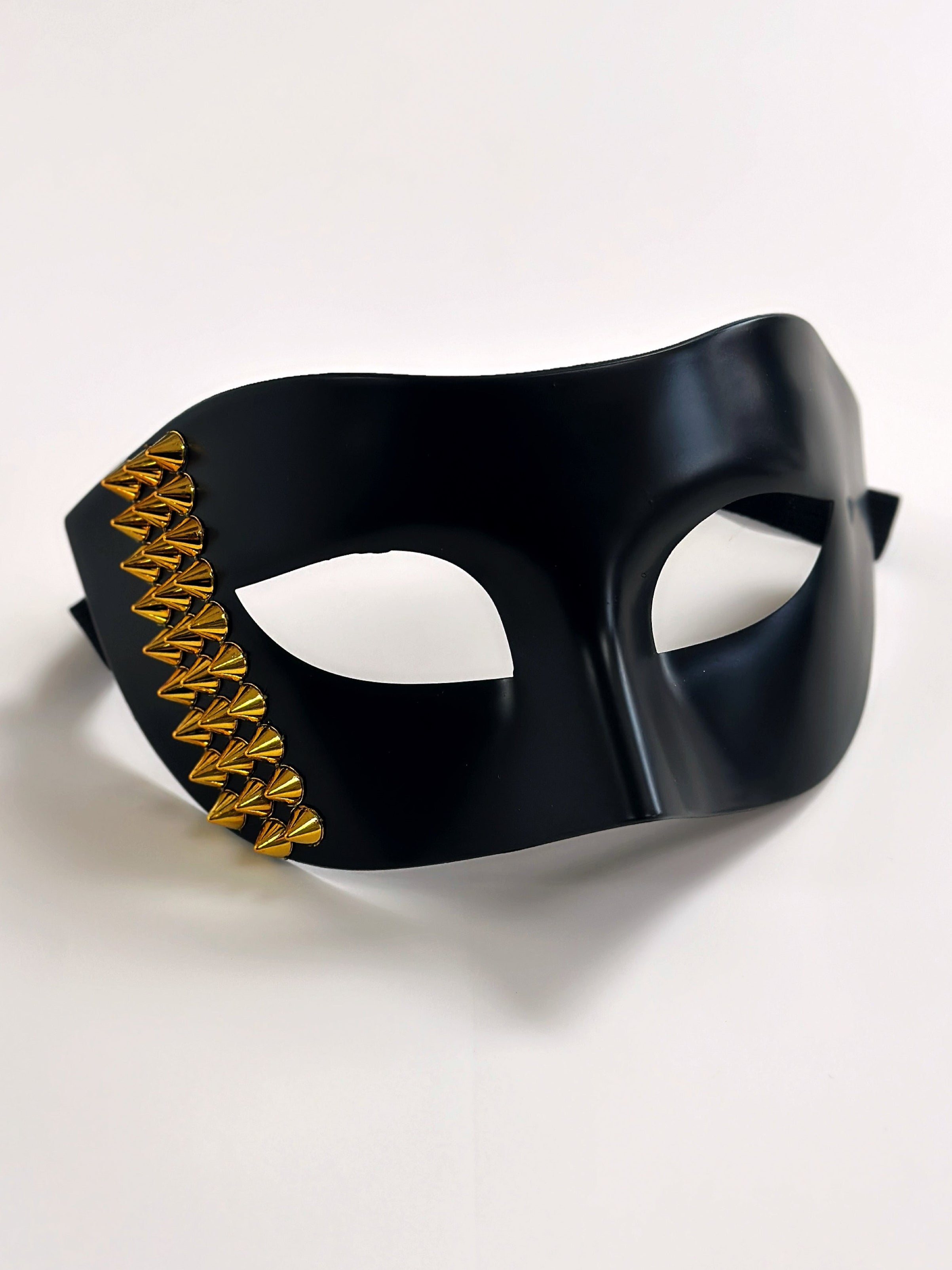 Black masquerade mask for men with gold stud details, perfect for edgy masquerade looks