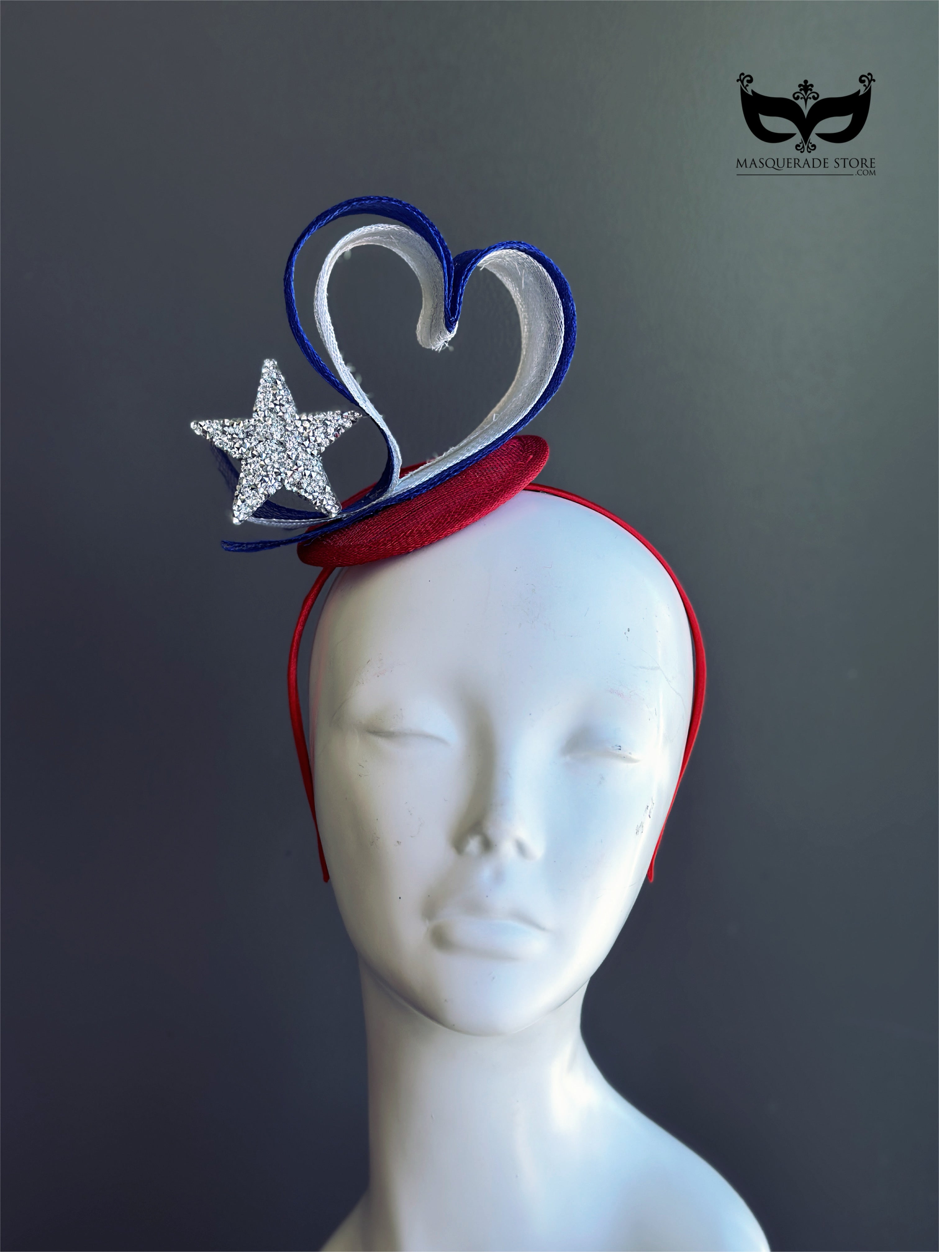 Red white and blue patriotic heart fascinator with sparkling rhinestone star, red mini hat base, sculptural loops, and slim red headband.