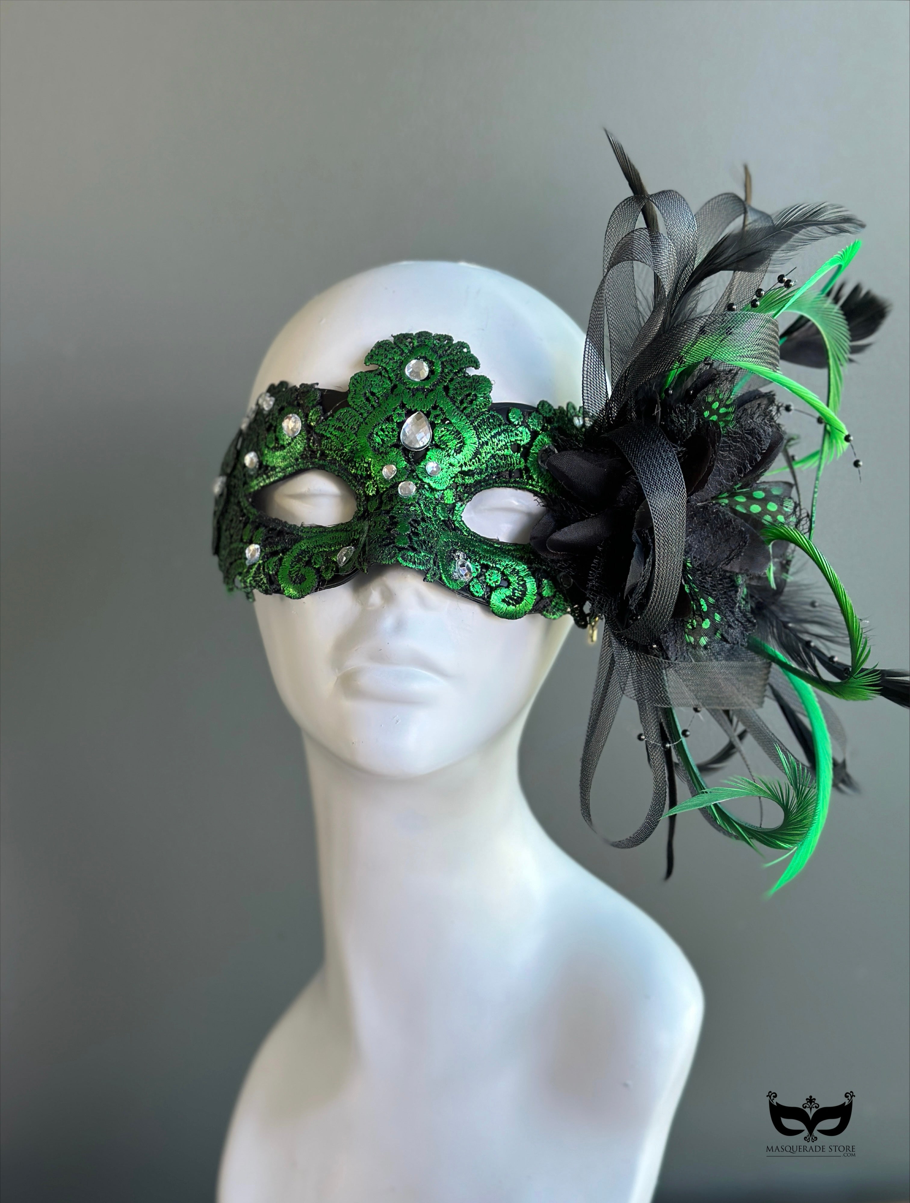 Green lace masquerade mask with iridescent crystal accents styled for formal masquerade balls and evening galas.