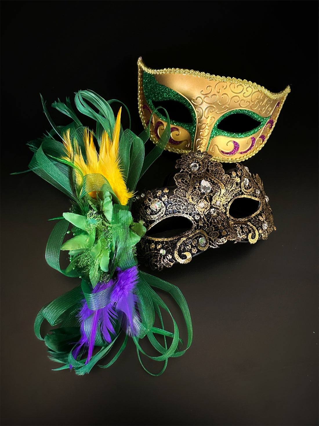 Festive couple’s Mardi Gras masquerade masks with vibrant feathers and ornate gold accents