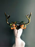 Fantasy crown headpiece with antlers and orange rose floral details, ideal for masquerade balls, forest queen looks, or fall festivals.