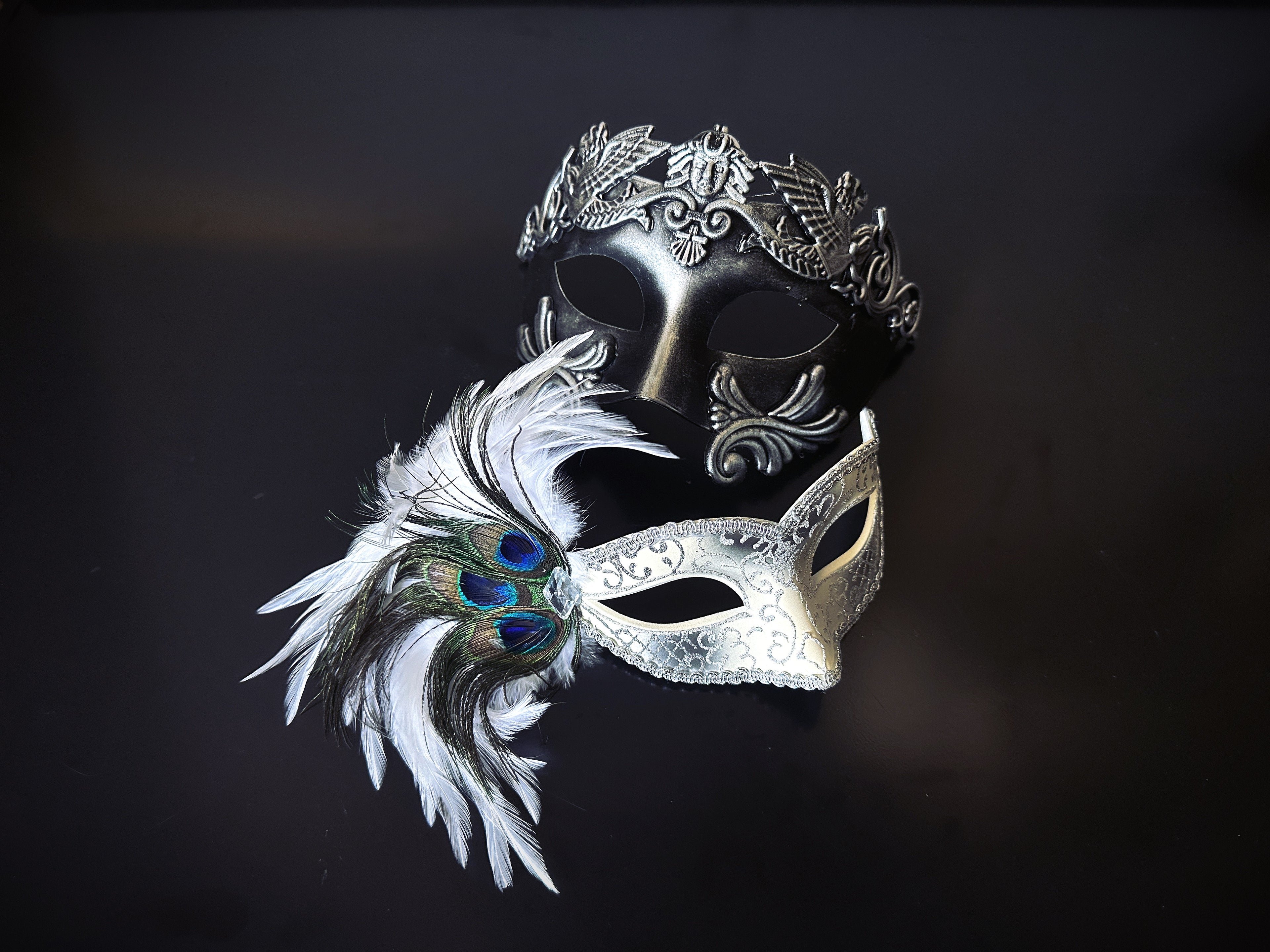 Silver and black masquerade mask set with peacock feathers and crown accents for prom, Mardi Gras, or ball-themed couples costumes