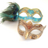 Couple’s masquerade mask set with a turquoise peacock feather mask and a gold glitter filigree mask for Venetian-style events.