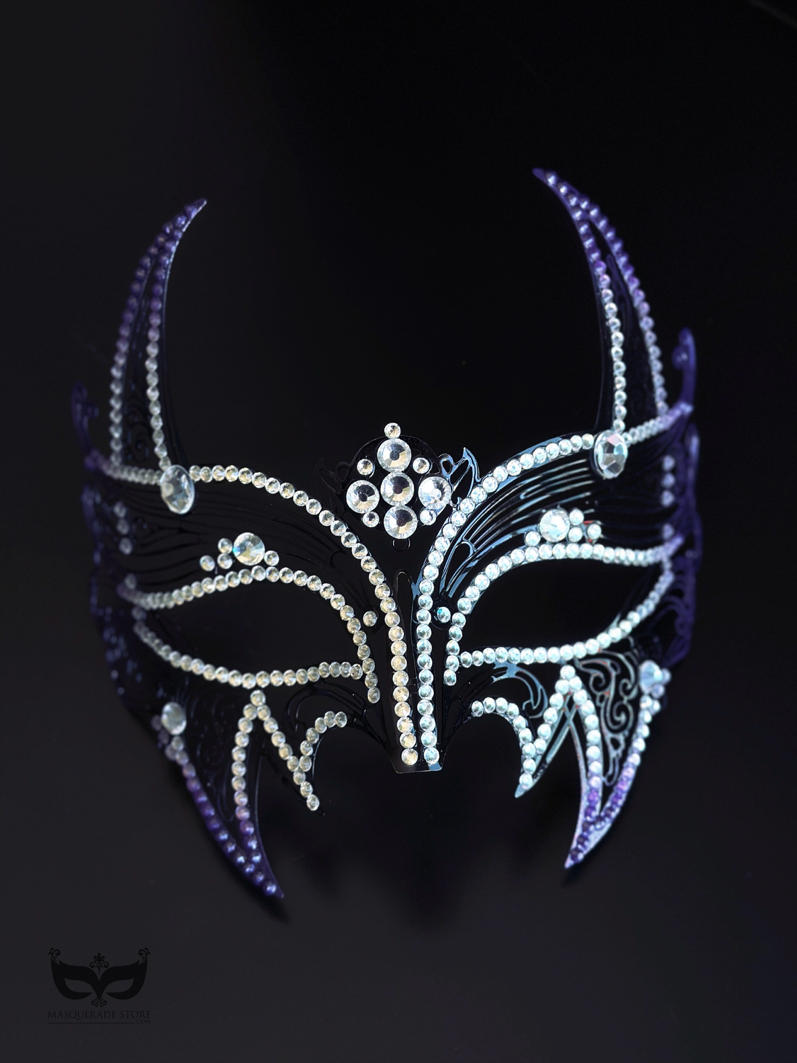 Purple and black horned masquerade mask with rhinestone accents, curved horn points, ribbon ties, and gothic Venetian-inspired styling for formal events.