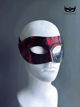 Red and black men’s masquerade half mask with Venetian textured finish.