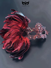 Red feather Venetian masquerade mask with rhinestones and spider detail for women.