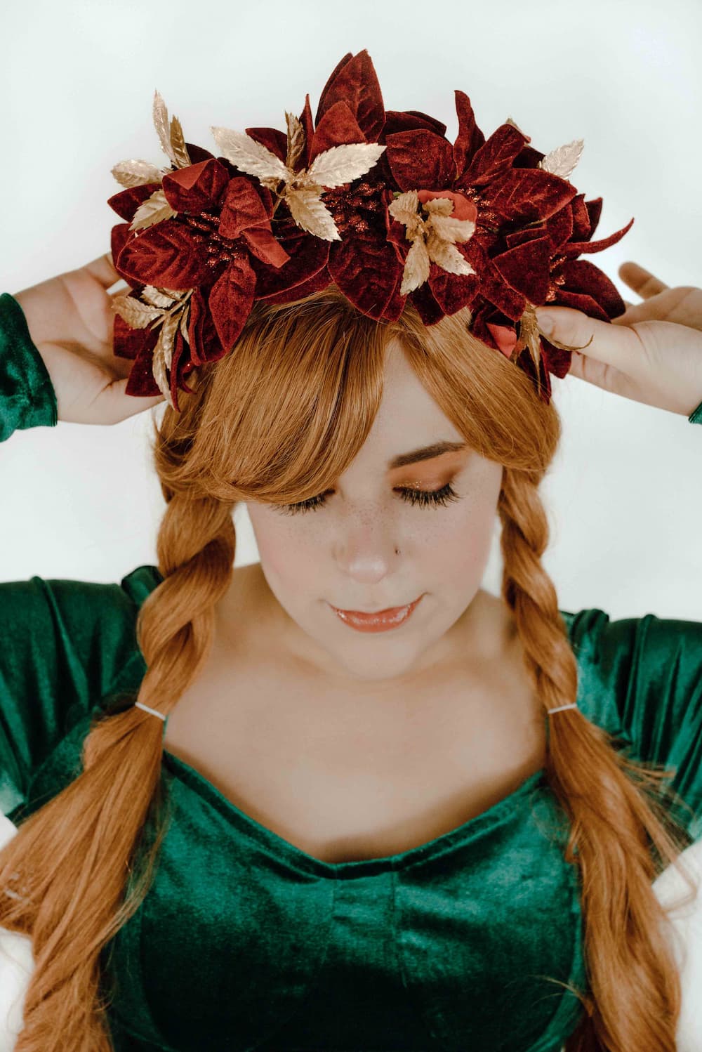 Masquerade holiday headpiece with red velvet poinsettias and gold floral accents