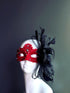Red lace masquerade mask with rhinestones, black feathers, and tulle accents for masquerade ball, prom, or Halloween.