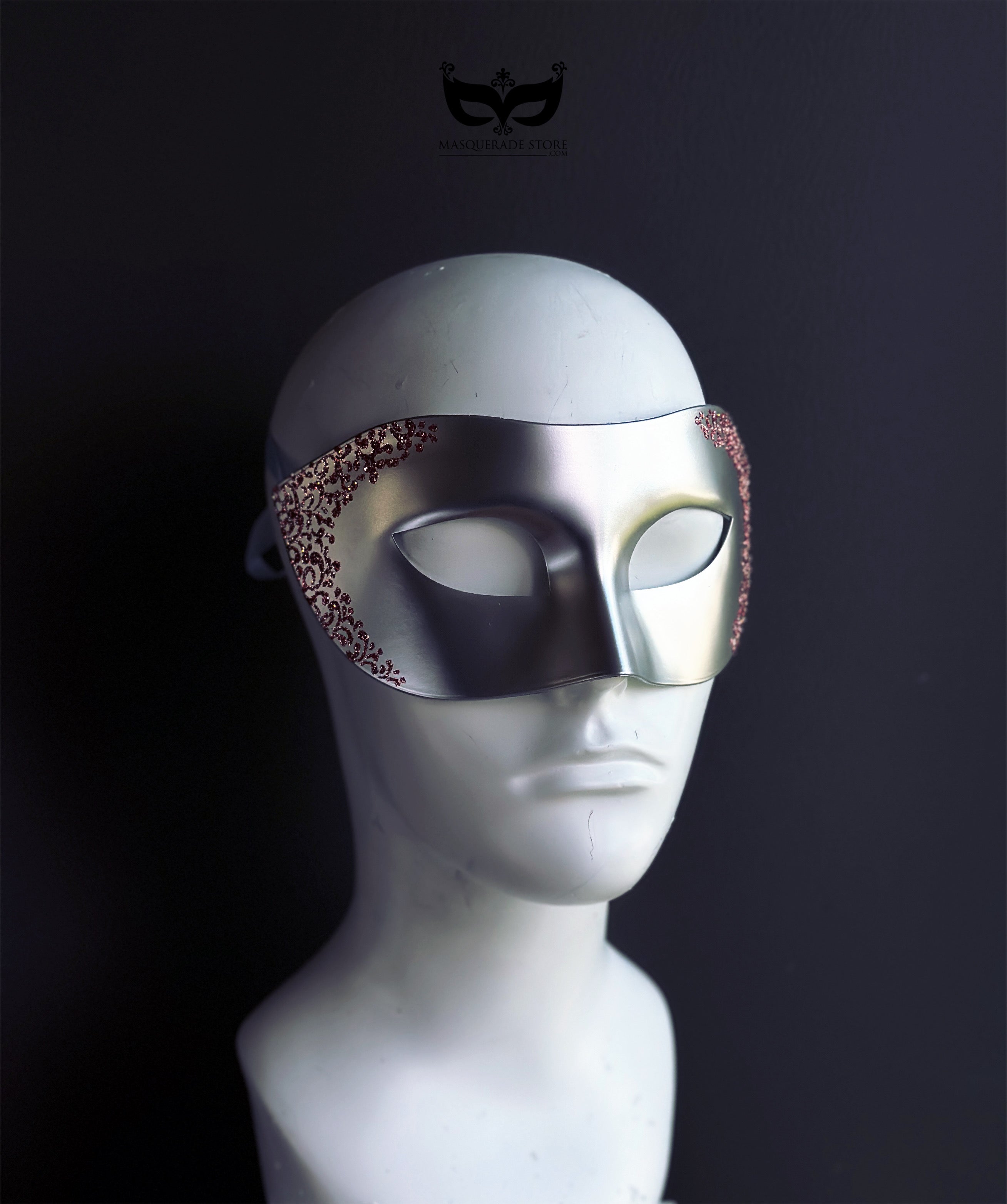 Silver Venetian masquerade eye mask with pink filigree detailing.