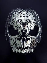 Intricate silver gothic skull face mask with cutout eyes and decorative design